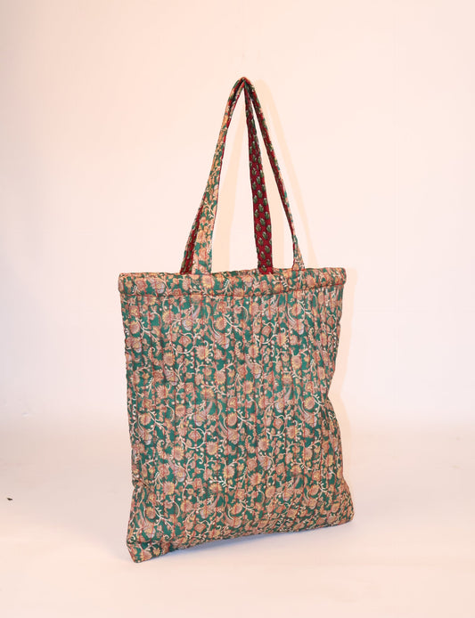 Elevate your style sustainably with our QUILTED SHOPPER BAG. Soft textures, vibrant colors, and a positive impact on people and the planet. Perfect for the office, shopping, or happy hour. Crafted from pre-loved saris for eco-conscious fashionistas!