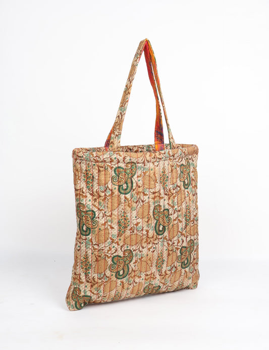 Elevate your style sustainably with our QUILTED SHOPPER BAG. Soft textures, vibrant colors, and a positive impact on people and the planet. Perfect for the office, shopping, or happy hour. Crafted from pre-loved saris for eco-conscious fashionistas!