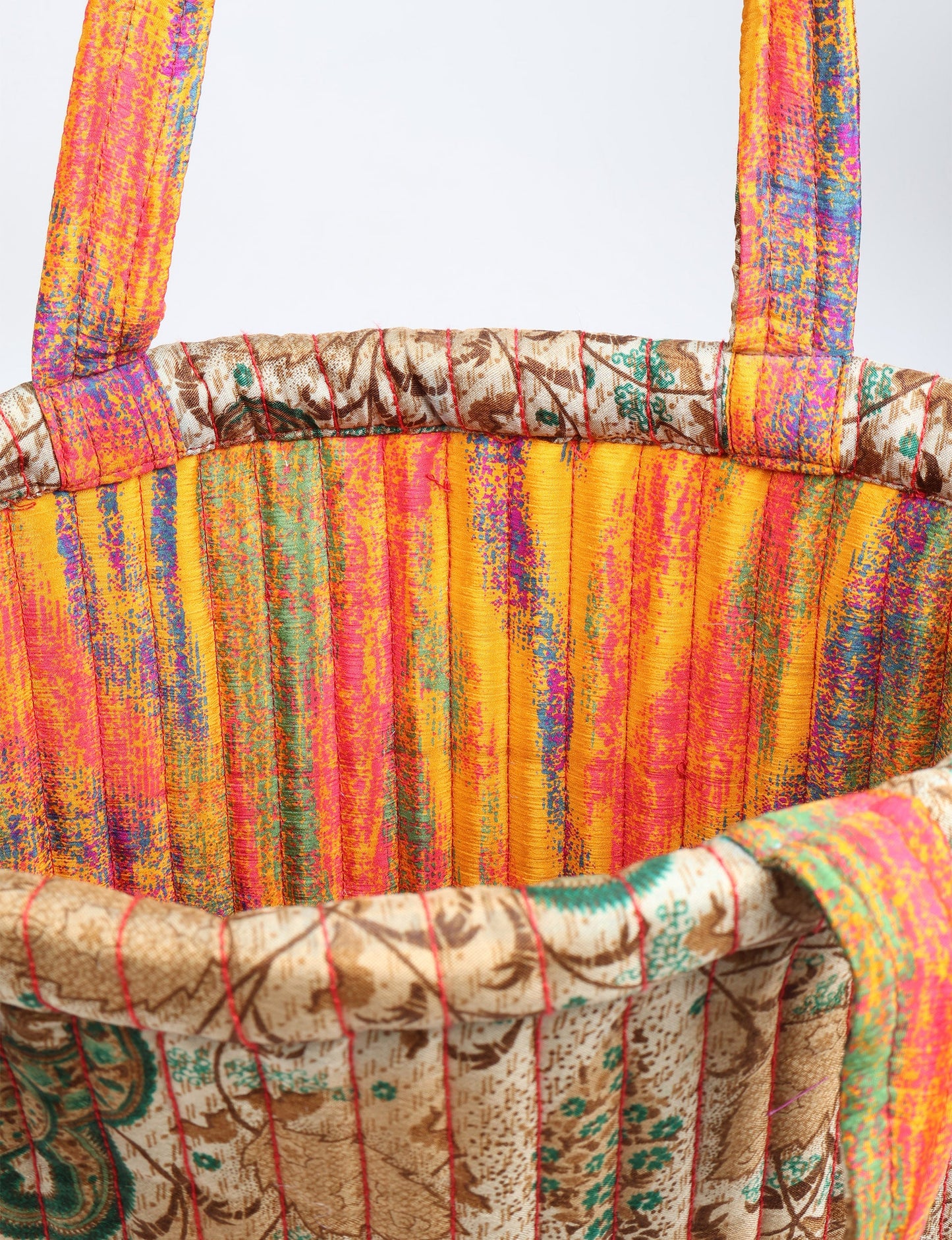 Elevate your style sustainably with our QUILTED SHOPPER BAG. Soft textures, vibrant colors, and a positive impact on people and the planet. Perfect for the office, shopping, or happy hour. Crafted from pre-loved saris for eco-conscious fashionistas!