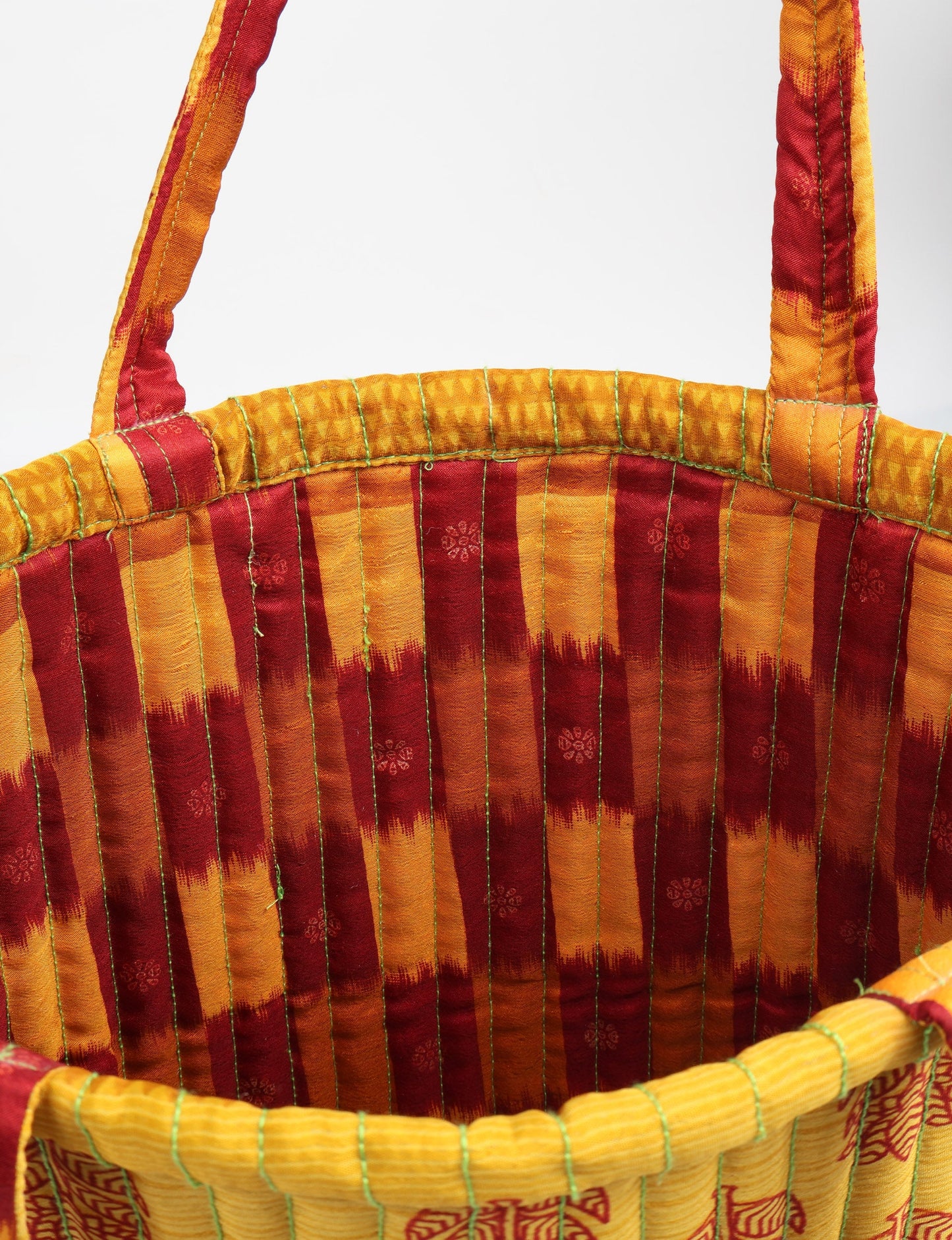 Elevate your style sustainably with our QUILTED SHOPPER BAG. Soft textures, vibrant colors, and a positive impact on people and the planet. Perfect for the office, shopping, or happy hour. Crafted from pre-loved saris for eco-conscious fashionistas!