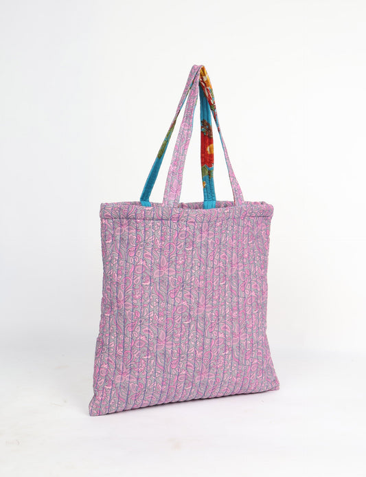 Elevate your style sustainably with our QUILTED SHOPPER BAG. Soft textures, vibrant colors, and a positive impact on people and the planet. Perfect for the office, shopping, or happy hour. Crafted from pre-loved saris for eco-conscious fashionistas!