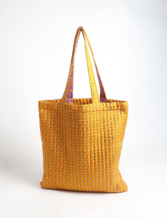 Elevate your style sustainably with our QUILTED SHOPPER BAG. Soft textures, vibrant colors, and a positive impact on people and the planet. Perfect for the office, shopping, or happy hour. Crafted from pre-loved saris for eco-conscious fashionistas!