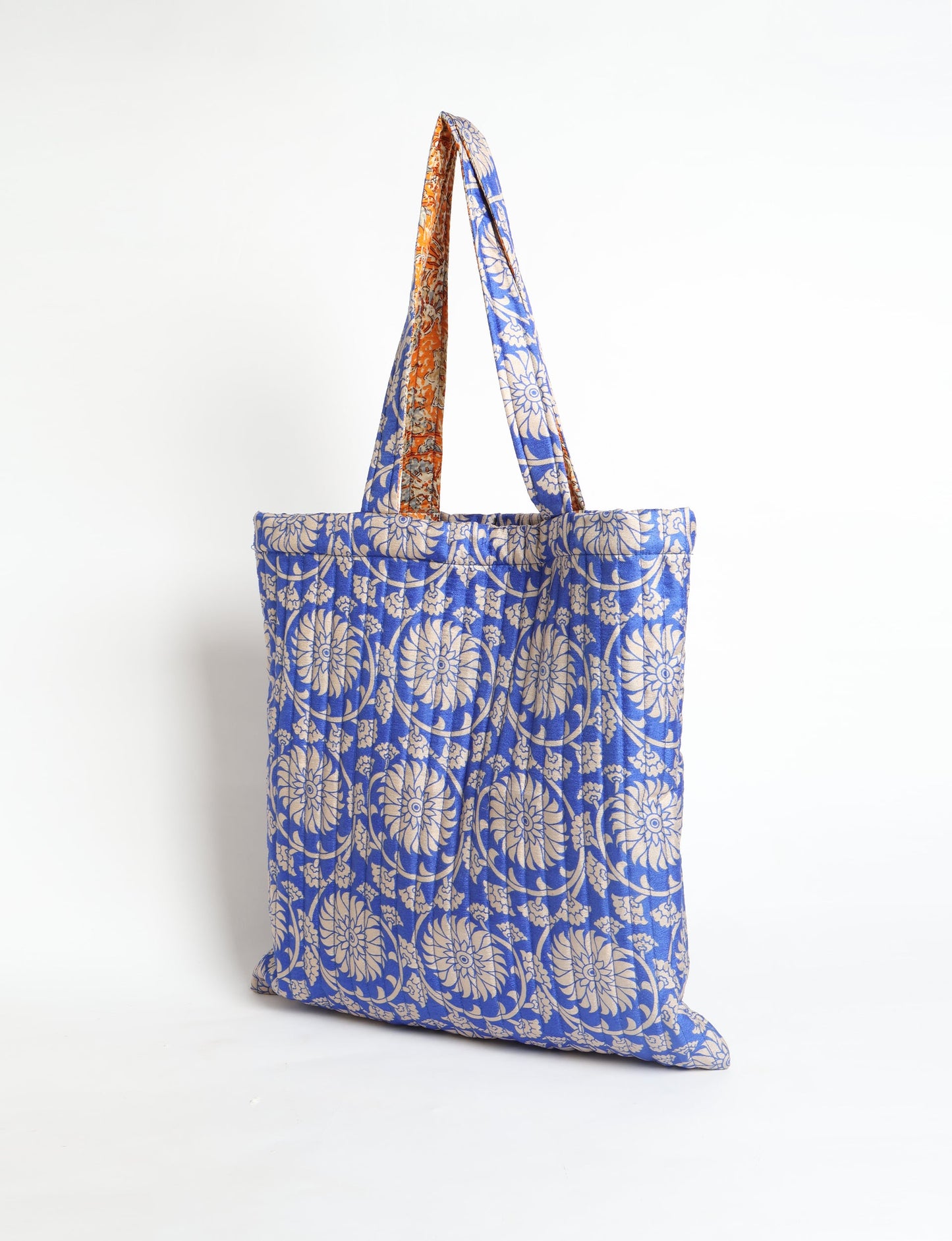 Elevate your style sustainably with our QUILTED SHOPPER BAG. Soft textures, vibrant colors, and a positive impact on people and the planet. Perfect for the office, shopping, or happy hour. Crafted from pre-loved saris for eco-conscious fashionistas!