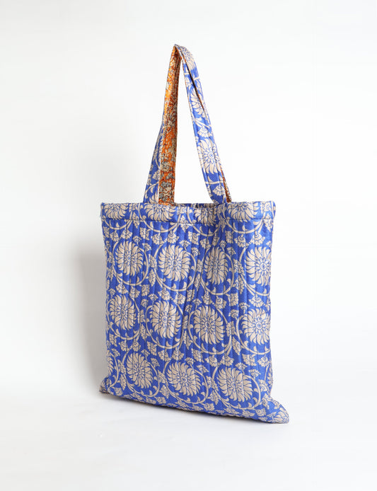 Elevate your style sustainably with our QUILTED SHOPPER BAG. Soft textures, vibrant colors, and a positive impact on people and the planet. Perfect for the office, shopping, or happy hour. Crafted from pre-loved saris for eco-conscious fashionistas!