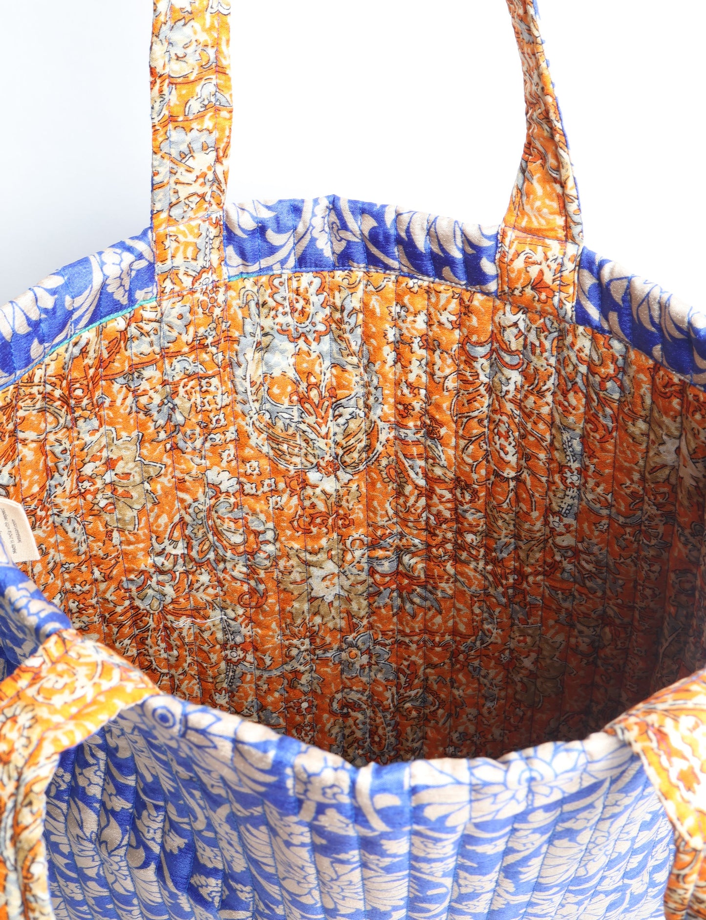 Elevate your style sustainably with our QUILTED SHOPPER BAG. Soft textures, vibrant colors, and a positive impact on people and the planet. Perfect for the office, shopping, or happy hour. Crafted from pre-loved saris for eco-conscious fashionistas!