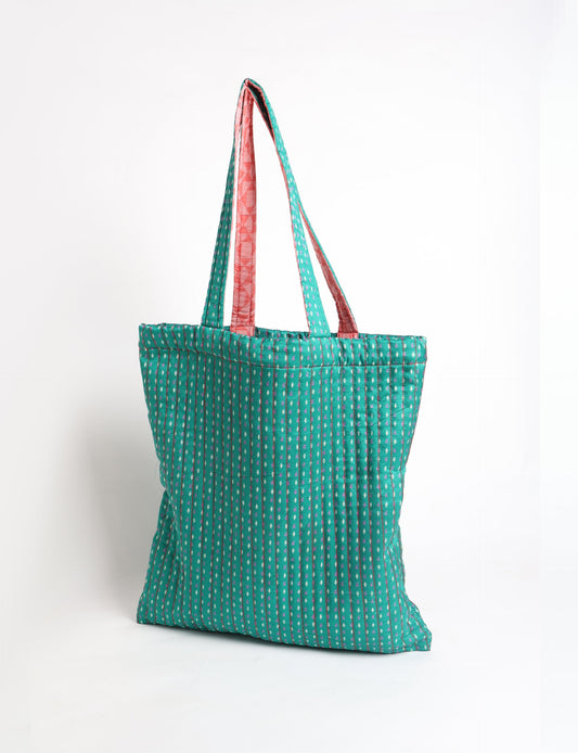 Elevate your style sustainably with our QUILTED SHOPPER BAG. Soft textures, vibrant colors, and a positive impact on people and the planet. Perfect for the office, shopping, or happy hour. Crafted from pre-loved saris for eco-conscious fashionistas!