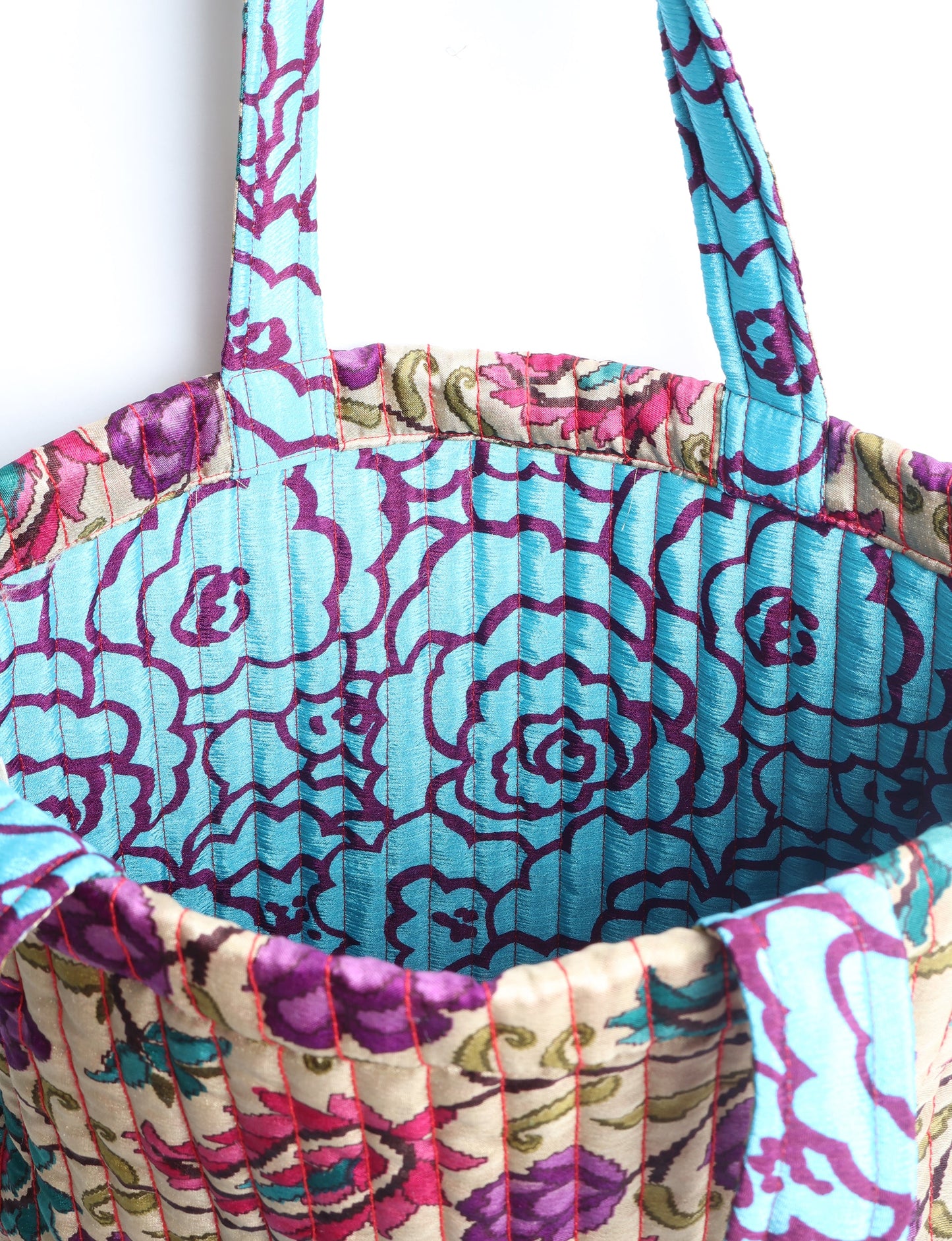 Elevate your style sustainably with our QUILTED SHOPPER BAG. Soft textures, vibrant colors, and a positive impact on people and the planet. Perfect for the office, shopping, or happy hour. Crafted from pre-loved saris for eco-conscious fashionistas!