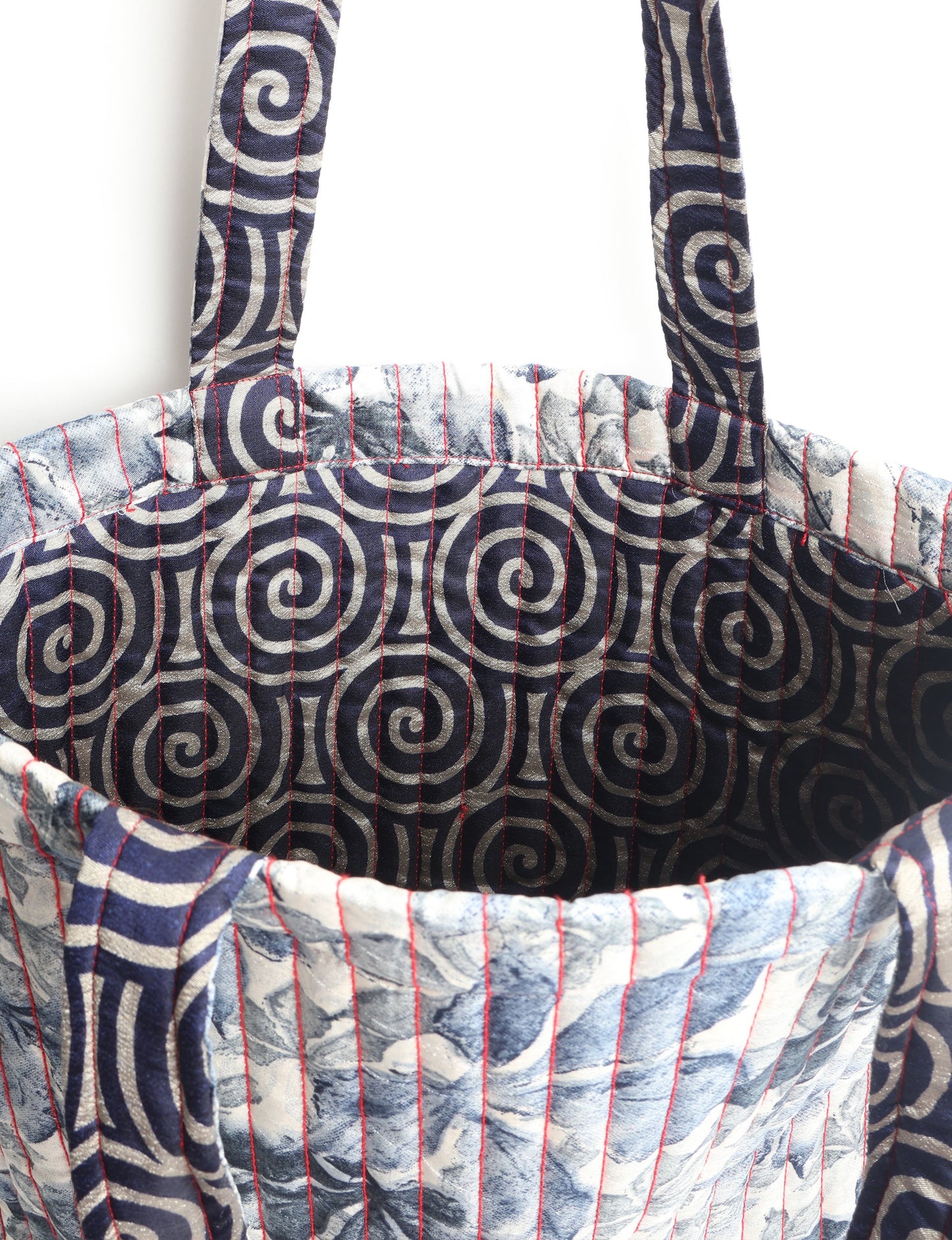 Elevate your style sustainably with our QUILTED SHOPPER BAG. Soft textures, vibrant colors, and a positive impact on people and the planet. Perfect for the office, shopping, or happy hour. Crafted from pre-loved saris for eco-conscious fashionistas!