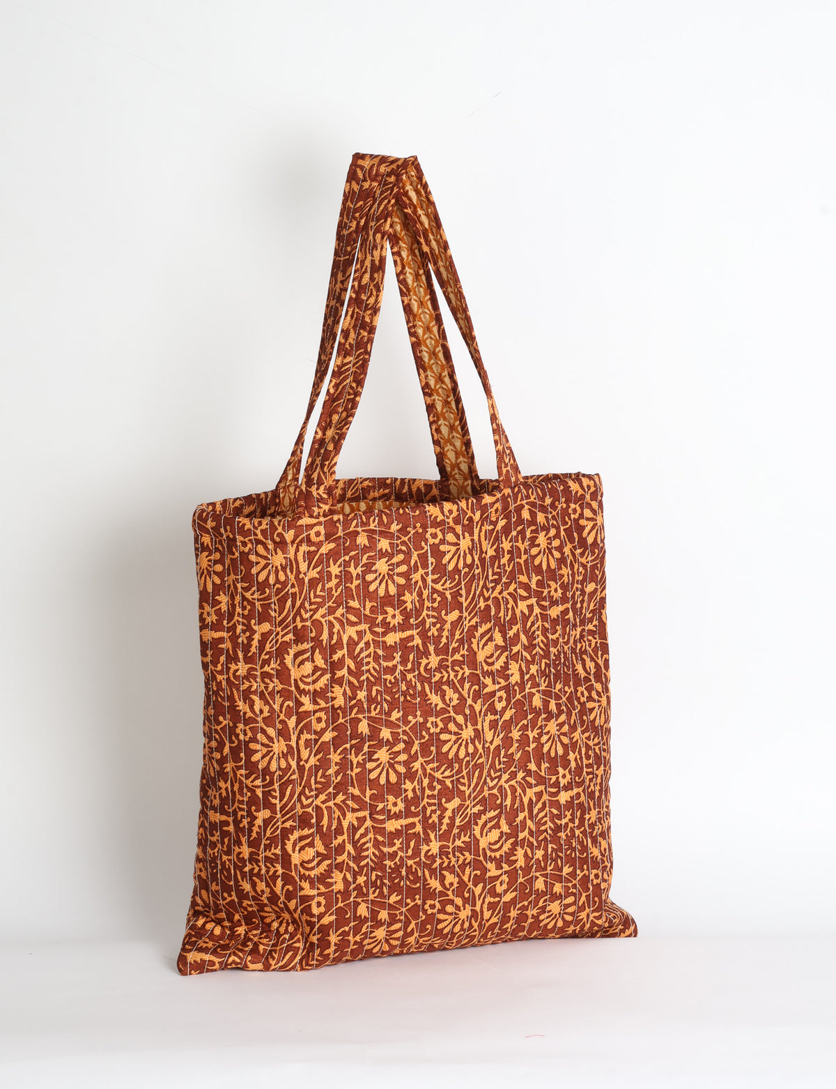 Elevate your style sustainably with our QUILTED SHOPPER BAG. Soft textures, vibrant colors, and a positive impact on people and the planet. Perfect for the office, shopping, or happy hour. Crafted from pre-loved saris for eco-conscious fashionistas!
