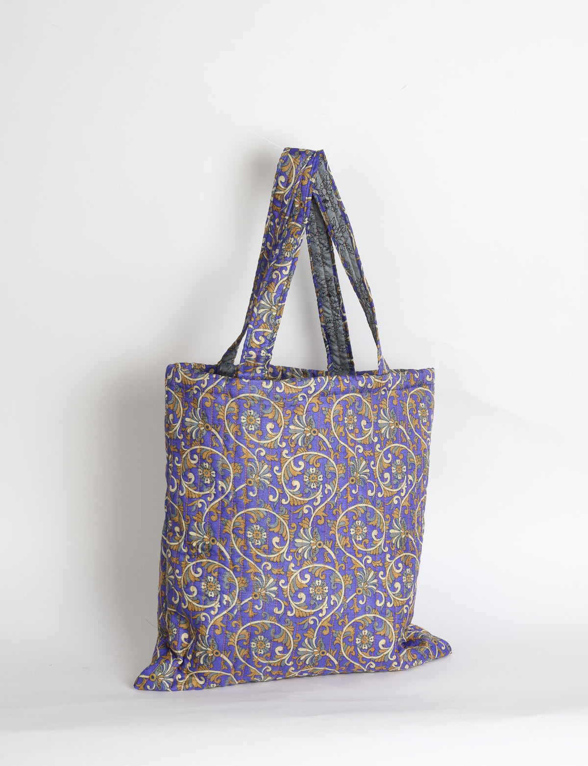 Elevate your style sustainably with our QUILTED SHOPPER BAG. Soft textures, vibrant colors, and a positive impact on people and the planet. Perfect for the office, shopping, or happy hour. Crafted from pre-loved saris for eco-conscious fashionistas!