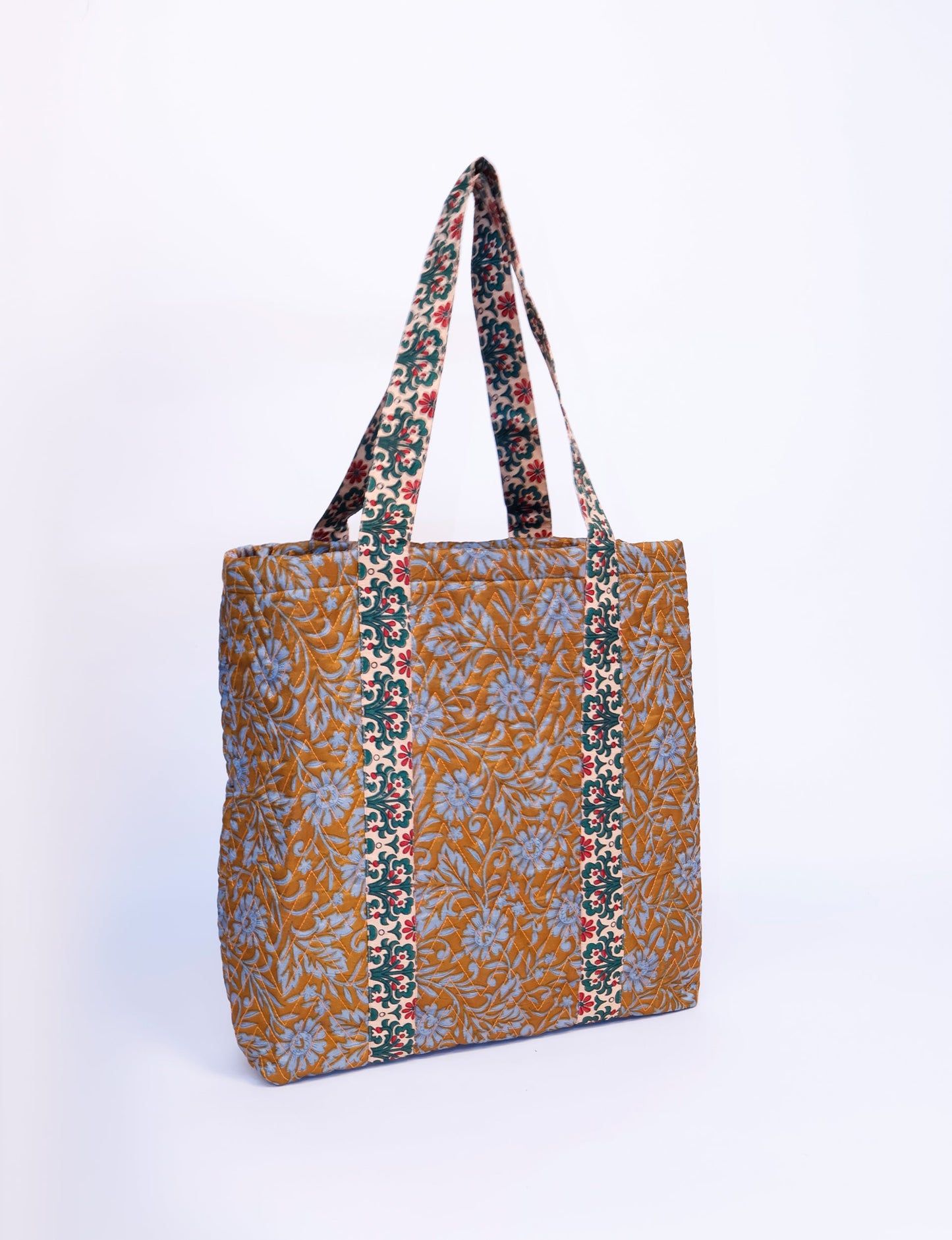 Elevate your style with our Quilted Tote Bag, a perfect fusion of fashion and sustainability. Made from vibrant upcycled saris, the newly quilted design adds strength and softness. With double fabric contrast straps and a unique sari lining, it's a statement of ethical elegance.