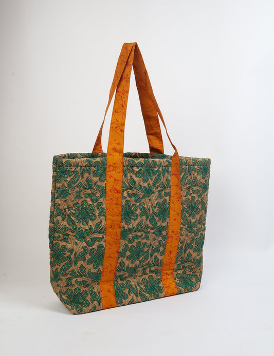 Elevate your style with our Quilted Tote Bag, a perfect fusion of fashion and sustainability. Made from vibrant upcycled saris, the newly quilted design adds strength and softness. With double fabric contrast straps and a unique sari lining, it's a statement of ethical elegance.