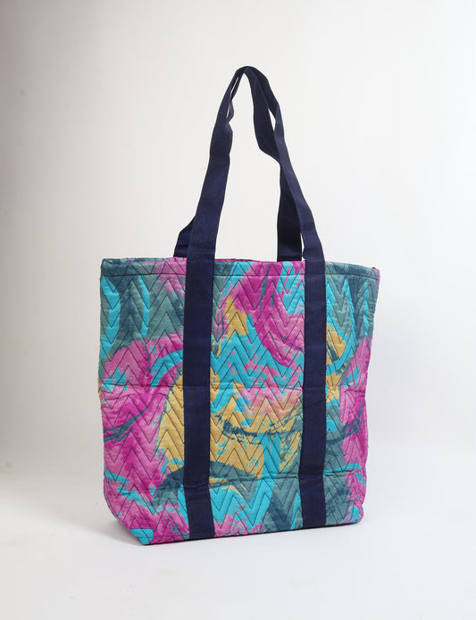Elevate your style with our Quilted Tote Bag, a perfect fusion of fashion and sustainability. Made from vibrant upcycled saris, the newly quilted design adds strength and softness. With double fabric contrast straps and a unique sari lining, it's a statement of ethical elegance.