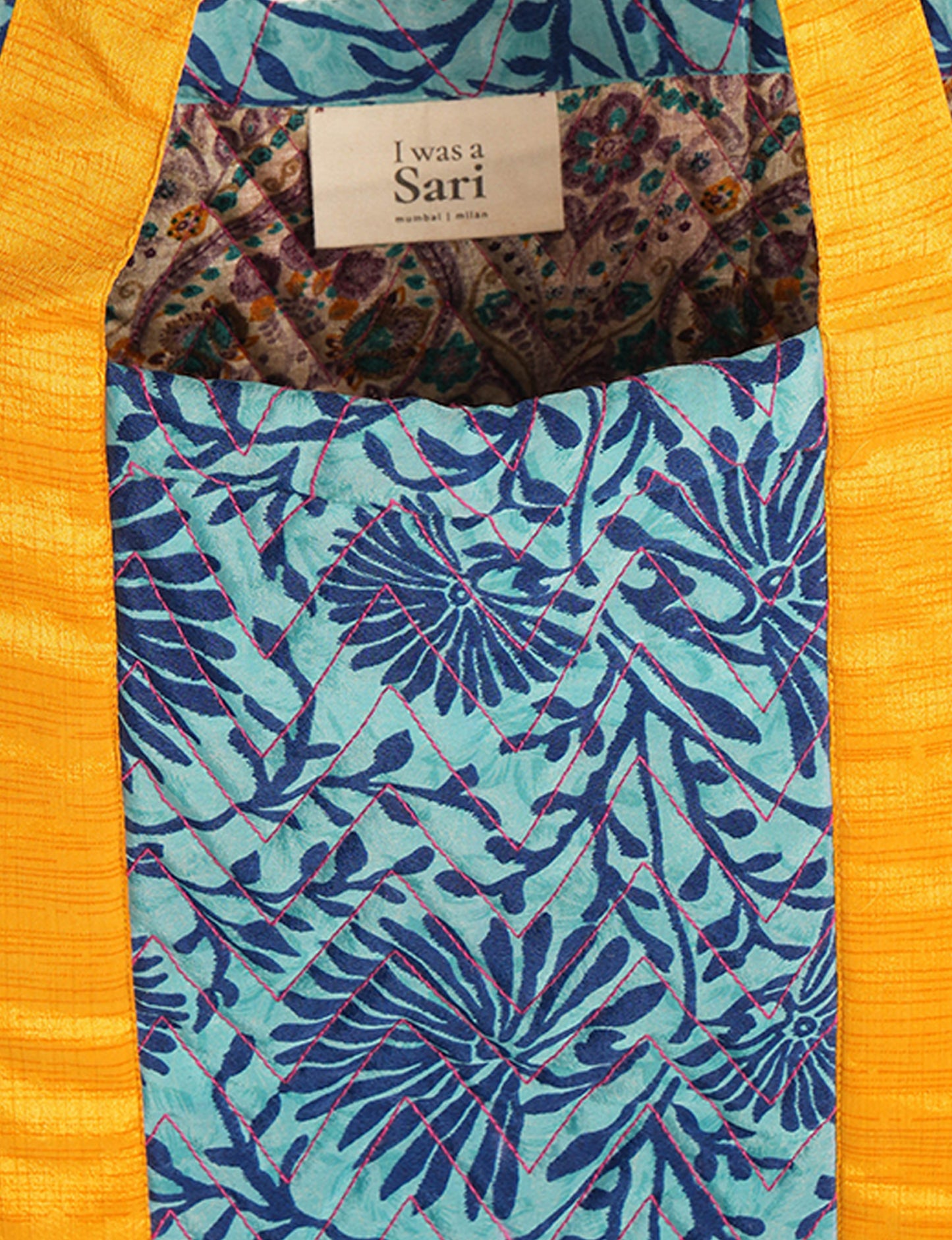 Elevate your style with our Quilted Tote Bag, a perfect fusion of fashion and sustainability. Made from vibrant upcycled saris, the newly quilted design adds strength and softness. With double fabric contrast straps and a unique sari lining, it's a statement of ethical elegance.