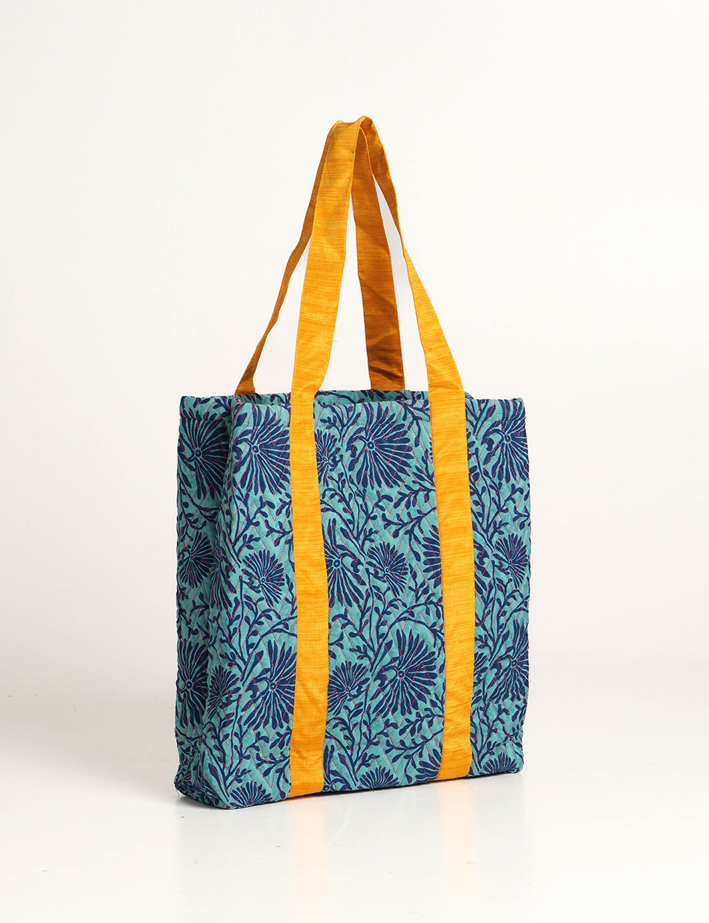 Elevate your style with our Quilted Tote Bag, a perfect fusion of fashion and sustainability. Made from vibrant upcycled saris, the newly quilted design adds strength and softness. With double fabric contrast straps and a unique sari lining, it's a statement of ethical elegance.