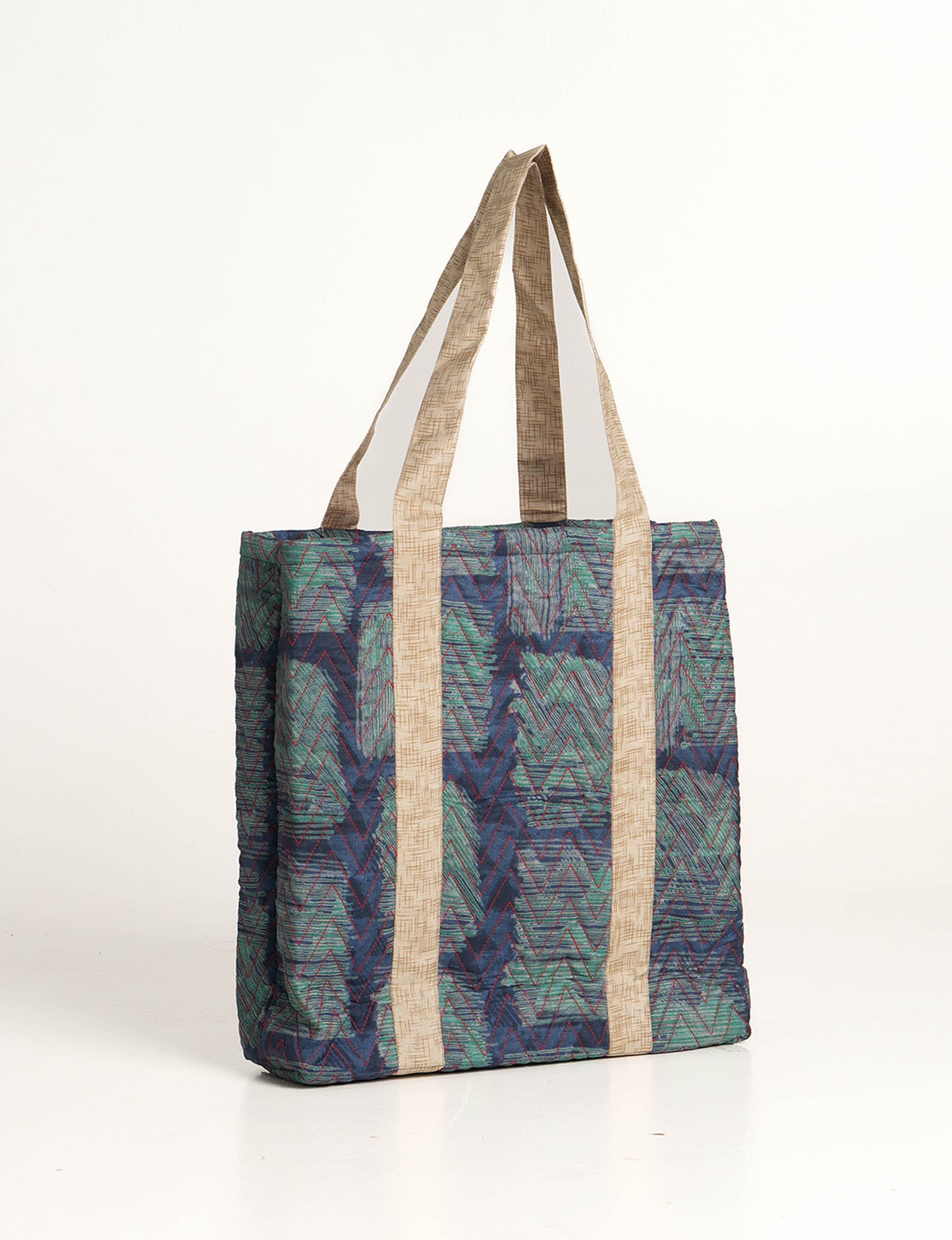 Elevate your style with our Quilted Tote Bag, a perfect fusion of fashion and sustainability. Made from vibrant upcycled saris, the newly quilted design adds strength and softness. With double fabric contrast straps and a unique sari lining, it's a statement of ethical elegance.