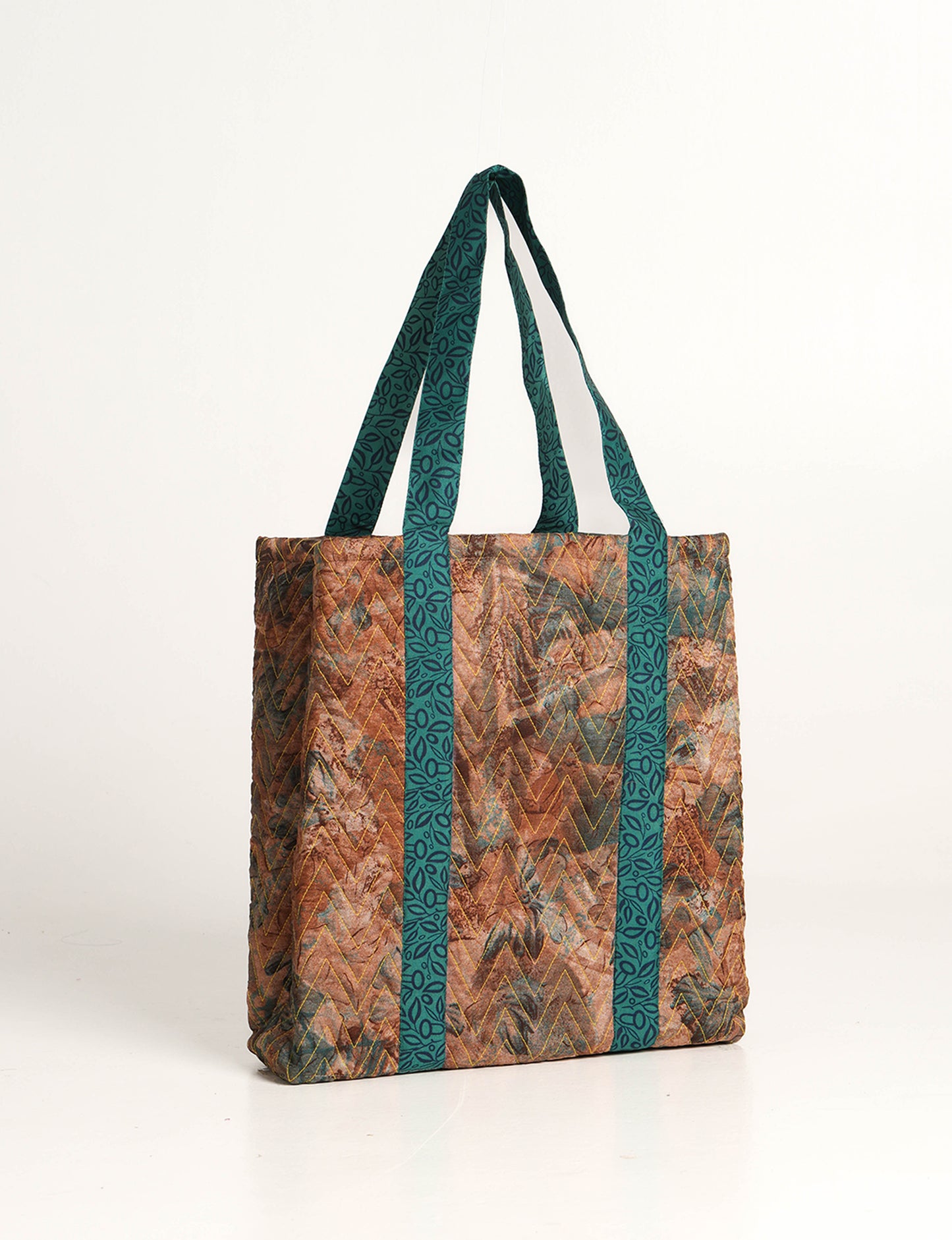 Elevate your style with our Quilted Tote Bag, a perfect fusion of fashion and sustainability. Made from vibrant upcycled saris, the newly quilted design adds strength and softness. With double fabric contrast straps and a unique sari lining, it's a statement of ethical elegance.