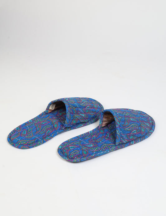 Blue quilted slippers with paisley pattern, open back, and cushioned footbed, shown flat on white background