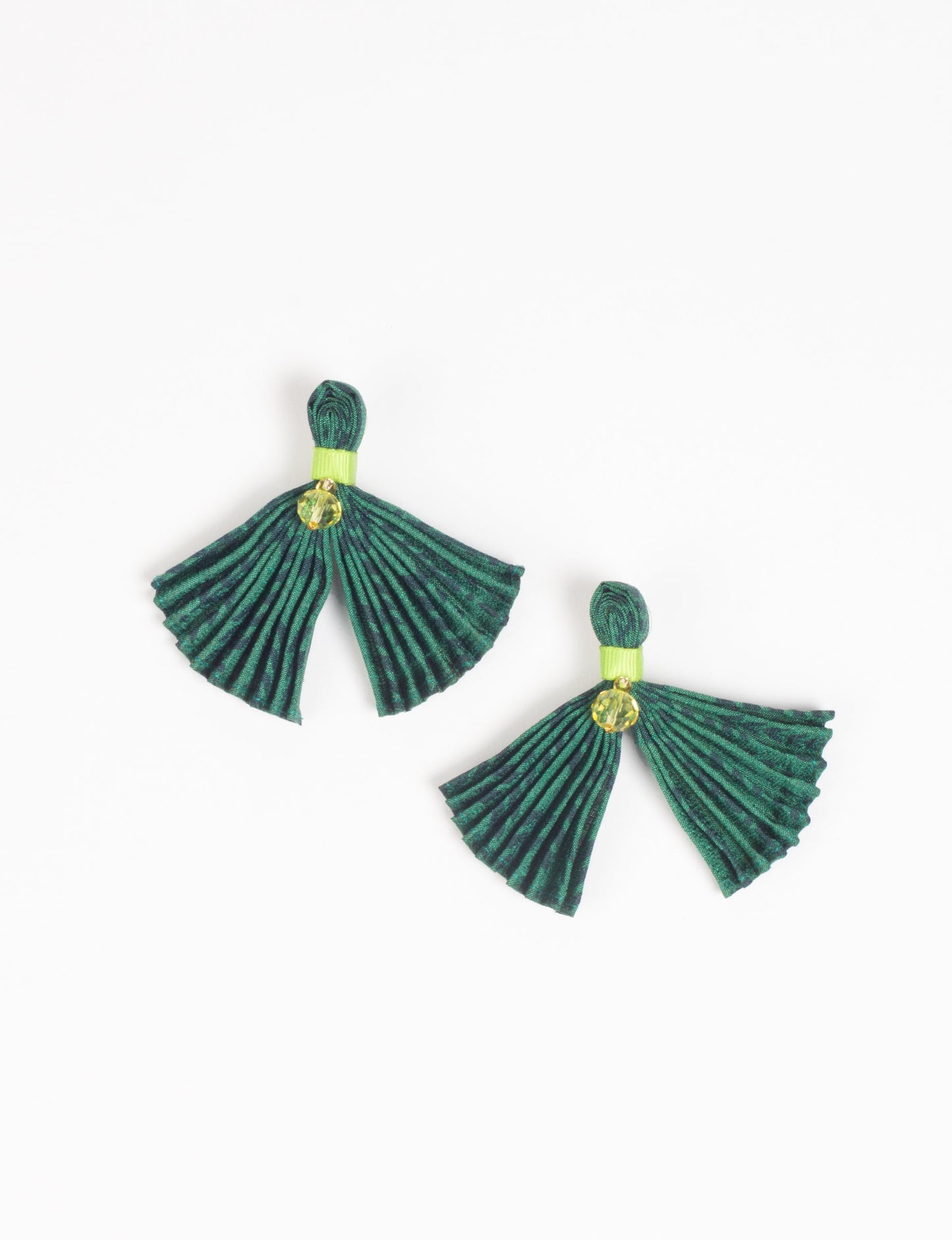 Adorn yourself sustainably with our PLEATED EARRINGS – fan-shaped wonders with a top knot and a tiny stone. Meticulously hand-pleated from Indian saris, these earrings reflect ethical clothing, green fashion, and slow fashion. Fastened with hypoallergy tested metal hooks, nickel, and lead-free, making them a conscious and stylish accessory.