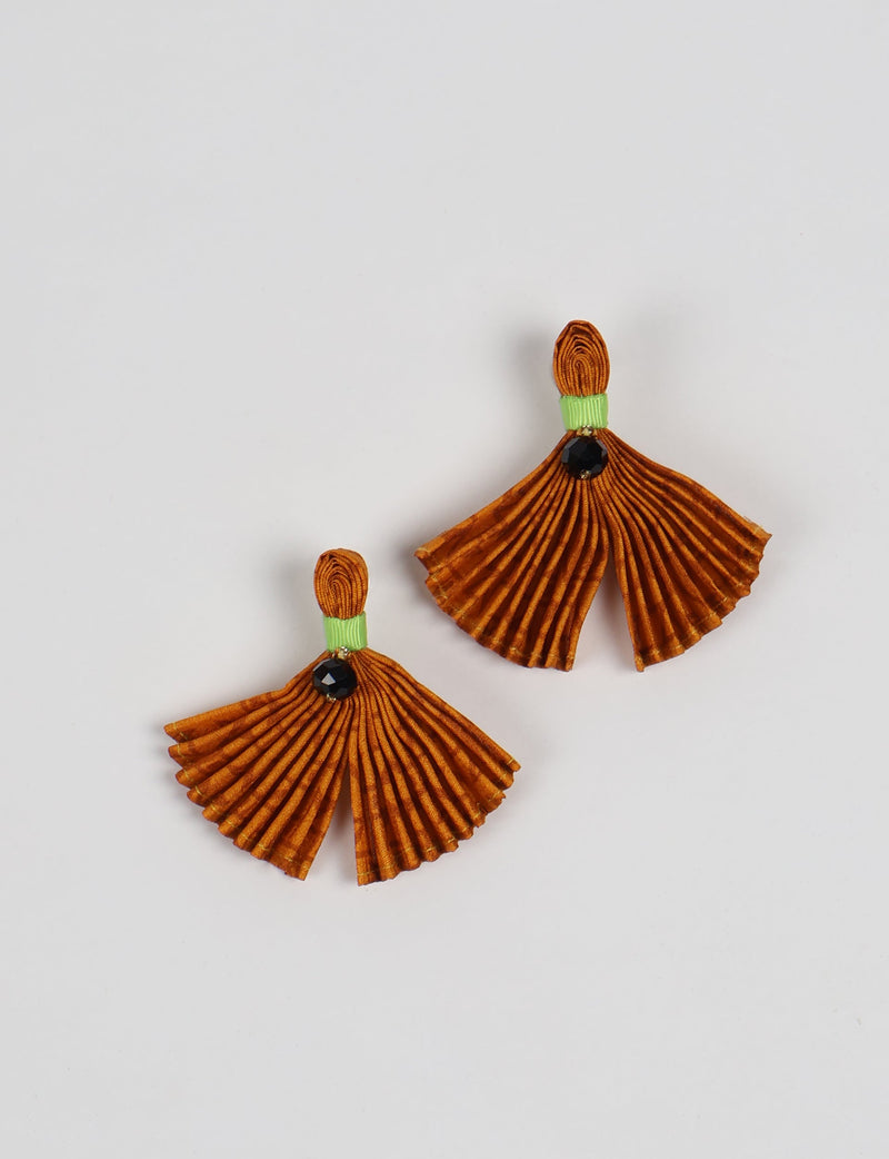 Orange pleated fabric earrings with green band and black bead detail, shown flat on white background