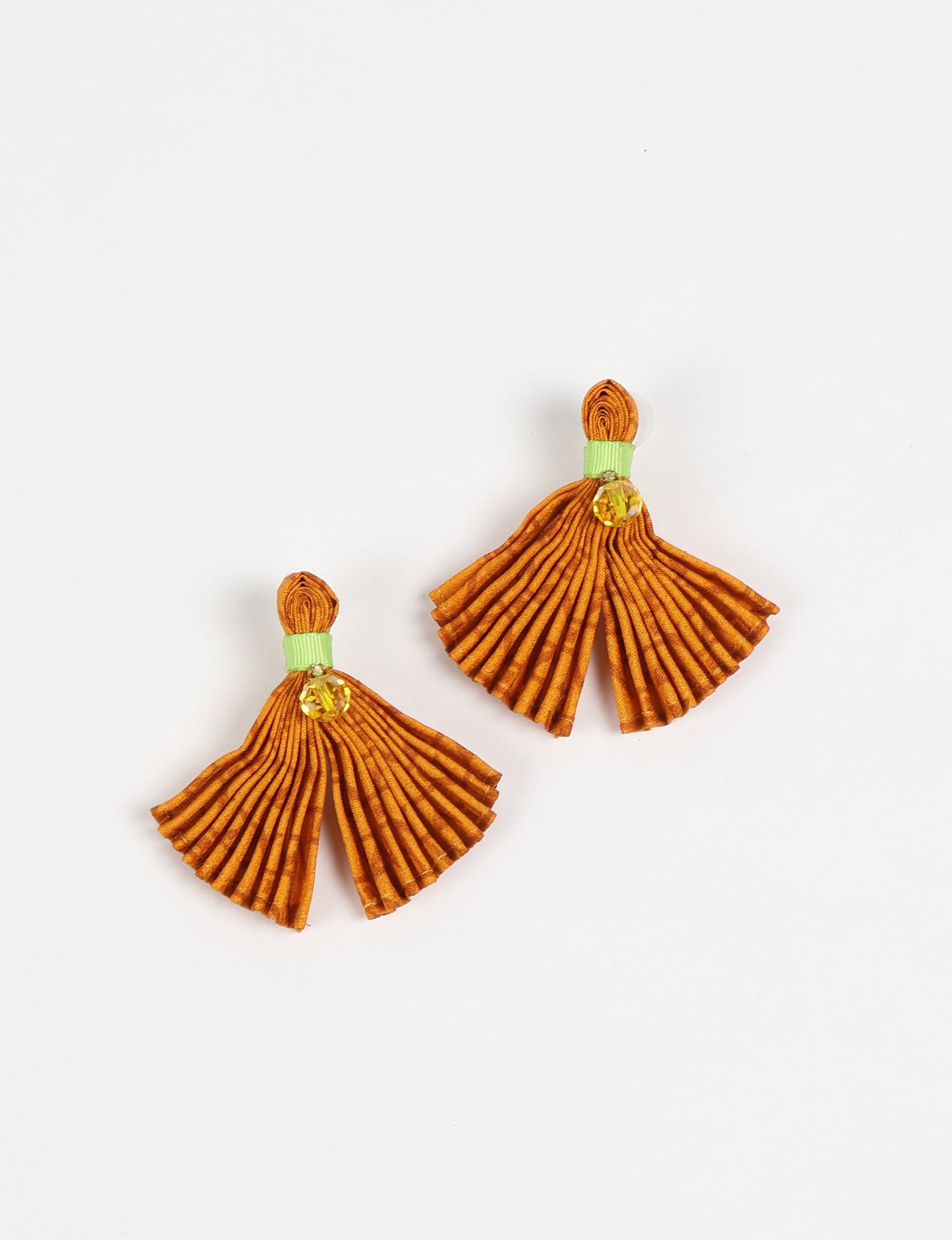 Adorn yourself sustainably with our PLEATED EARRINGS – fan-shaped wonders with a top knot and a tiny stone. Meticulously hand-pleated from Indian saris, these earrings reflect ethical clothing, green fashion, and slow fashion. Fastened with hypoallergy tested metal hooks, nickel, and lead-free, making them a conscious and stylish accessory.