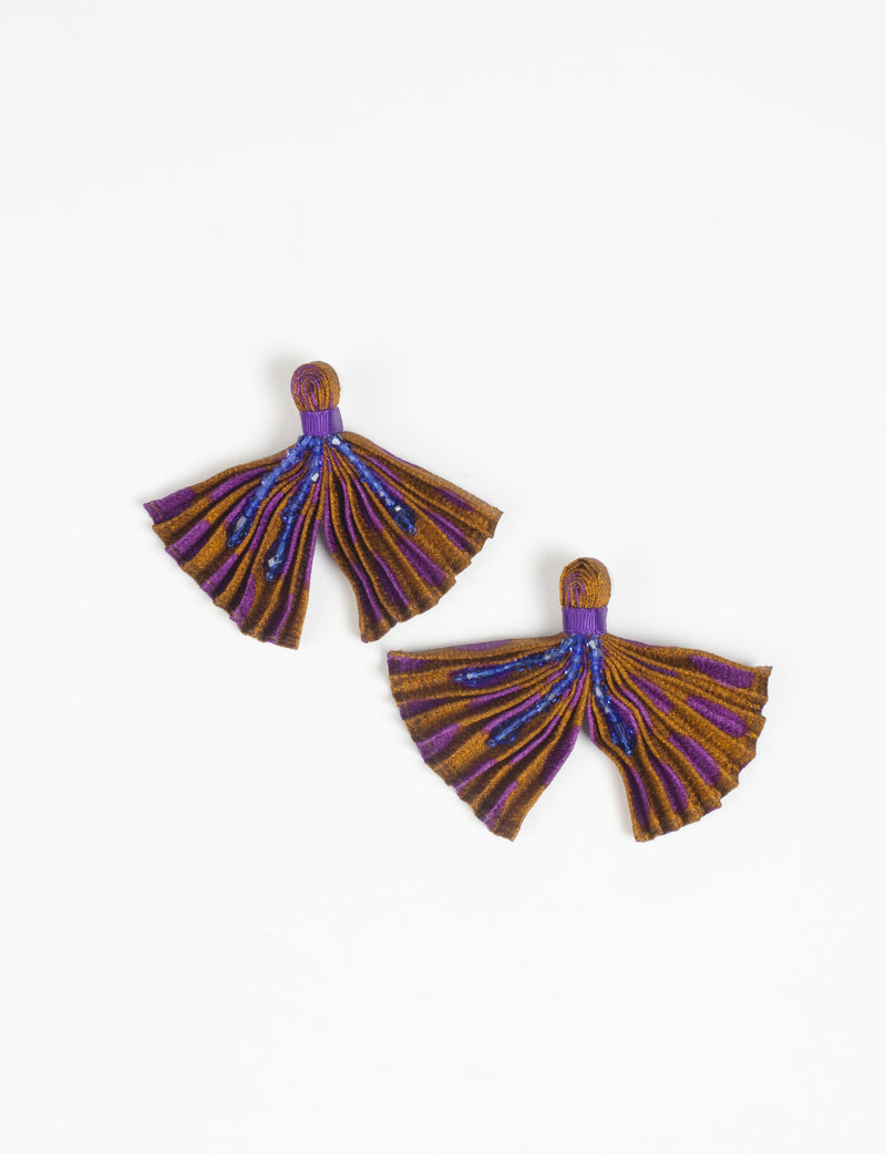 Pair of pleated fabric earrings in yellow and purple stripes with blue bead embellishments, shown flat on white background