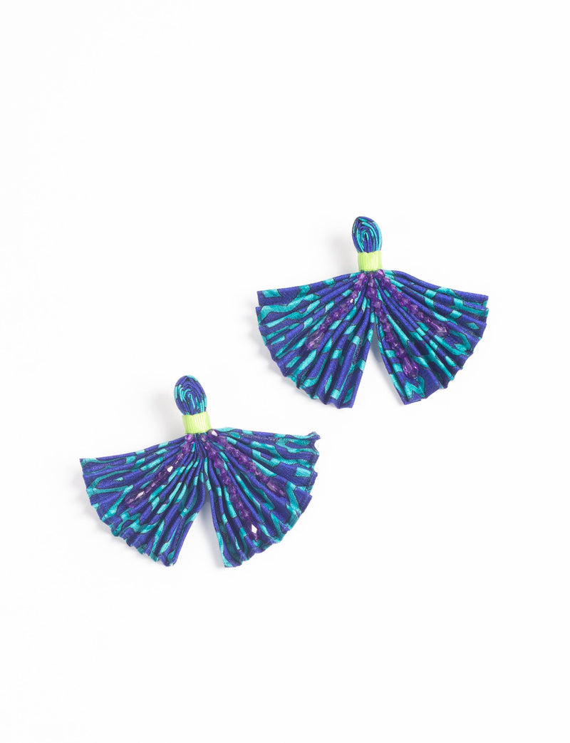 Pair of pleated fabric earrings in blue and teal abstract pattern with purple bead accents and lime green detail, flat lay view