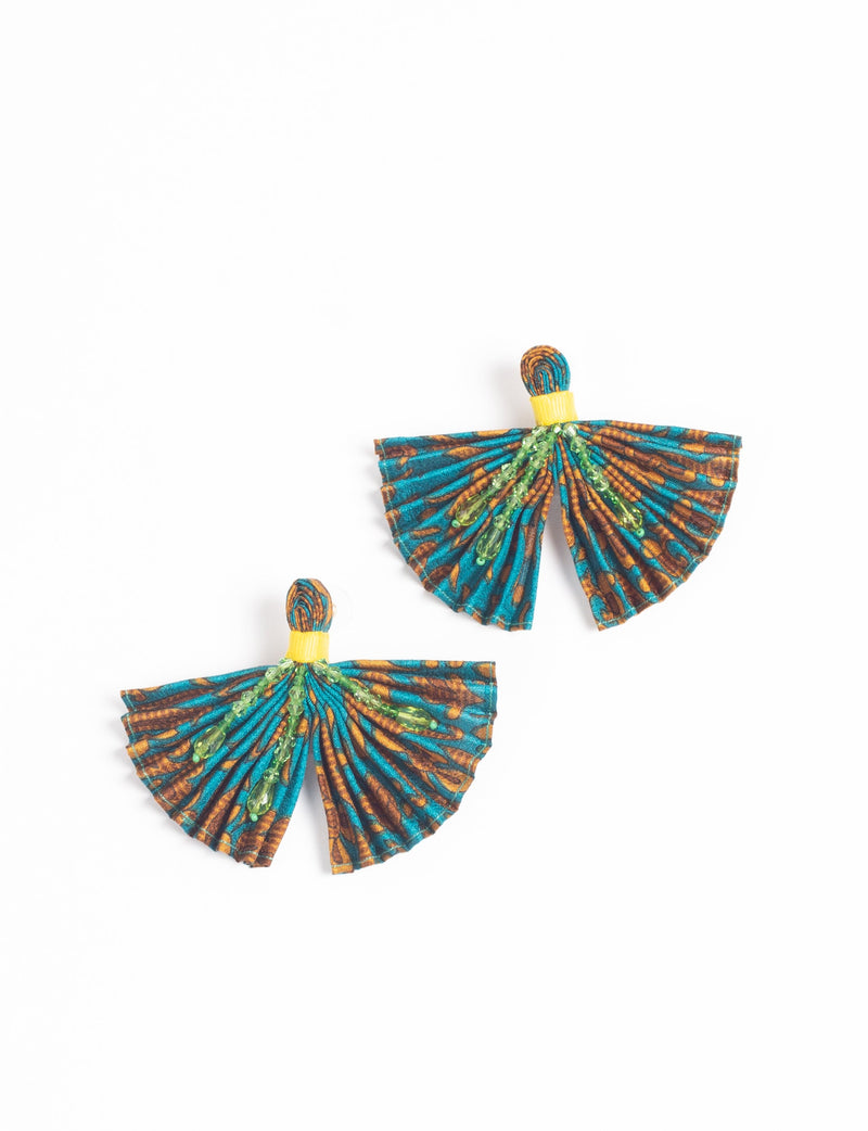 Pair of pleated fabric earrings in blue and brown abstract pattern with green bead embellishments and yellow accents, flat lay