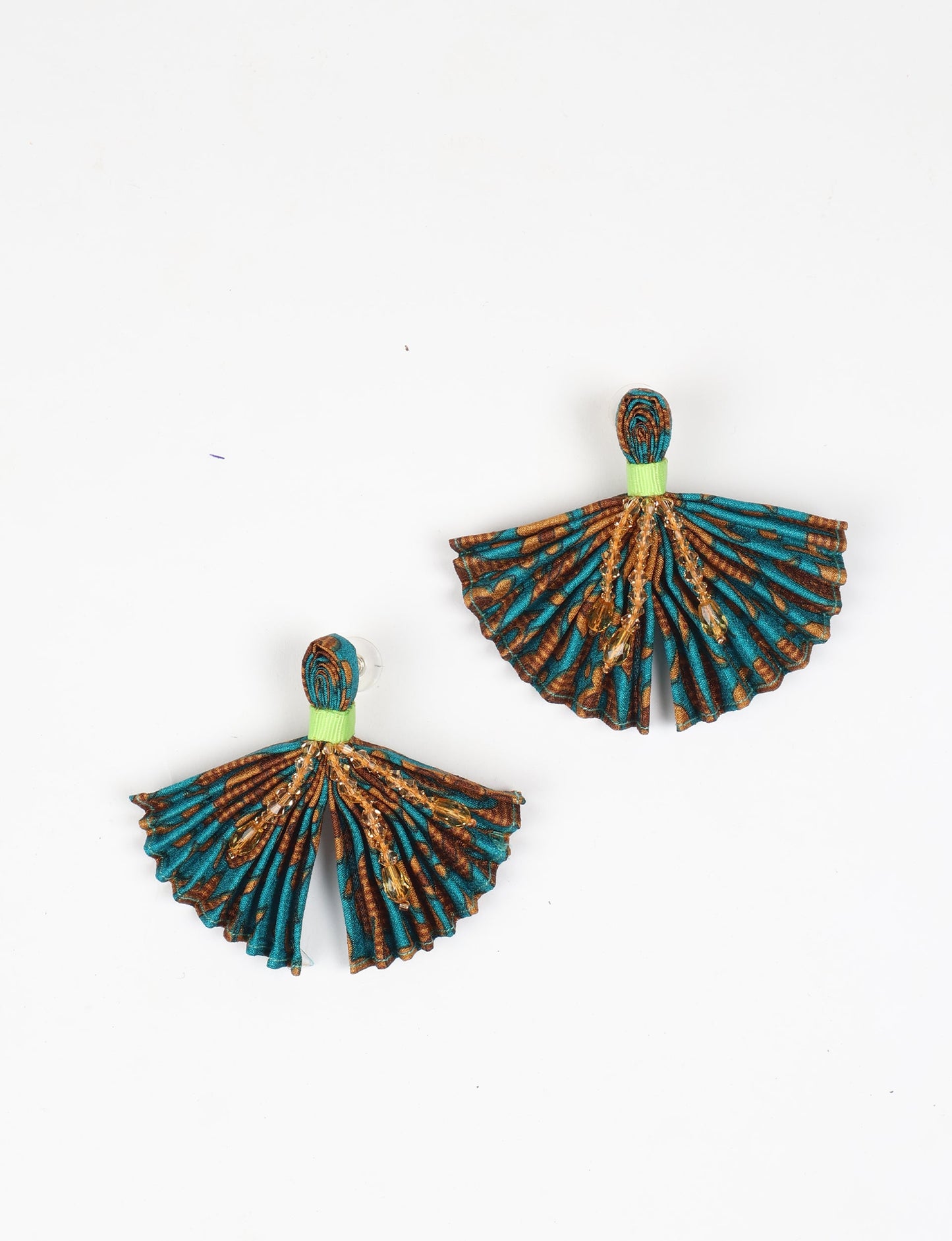 Elevate your look with our PLEATED EARRINGS – embellished with a beaded dangler, diamond-shaped metallic plate, and hook fastening. Crafted with innovative heat setting techniques on pre-loved saris, these earrings showcase ethical clothing, green fashion, and zero waste fashion. Hypoallergy tested metal hooks, nickel, and lead-free for a conscious and stylish accessory.