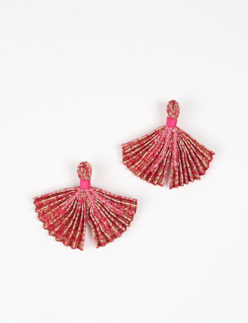 Pair of pleated fabric earrings in orange and pink abstract pattern with pink bead embellishments, flat lay on white background