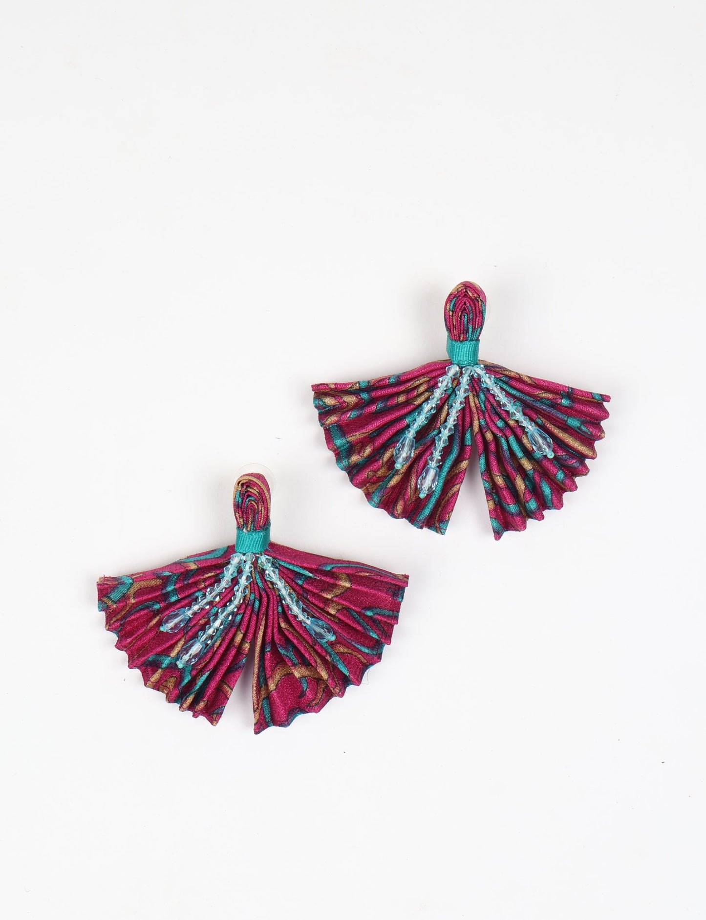 Elevate your look with our PLEATED EARRINGS – embellished with a beaded dangler, diamond-shaped metallic plate, and hook fastening. Crafted with innovative heat setting techniques on pre-loved saris, these earrings showcase ethical clothing, green fashion, and zero waste fashion. Hypoallergy tested metal hooks, nickel, and lead-free for a conscious and stylish accessory.