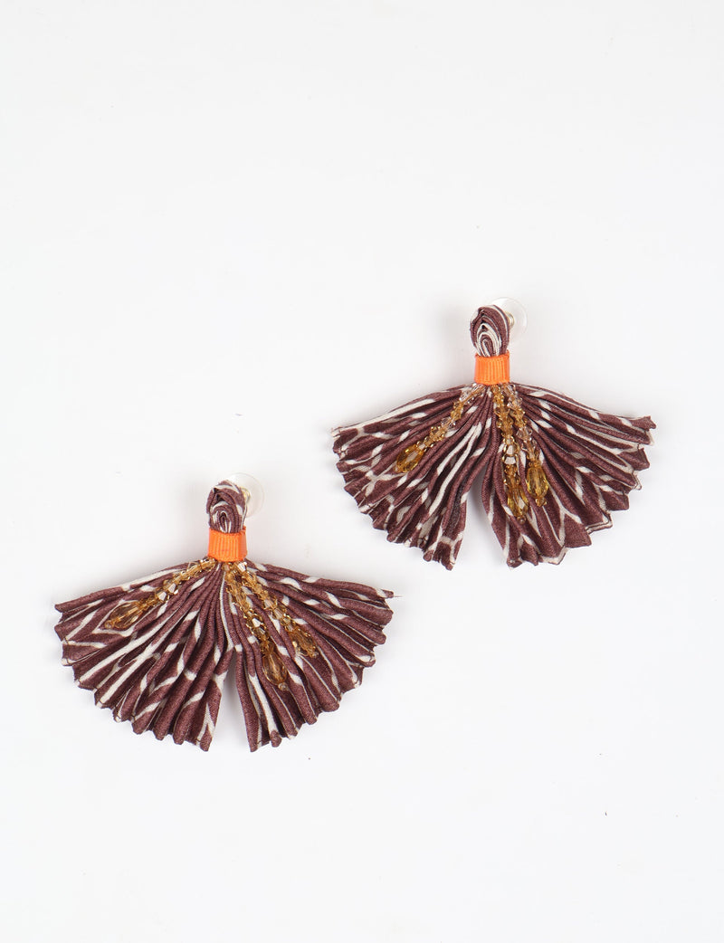 Brown pleated fabric earrings with abstract pattern and amber bead embellishments, shown flat on white background