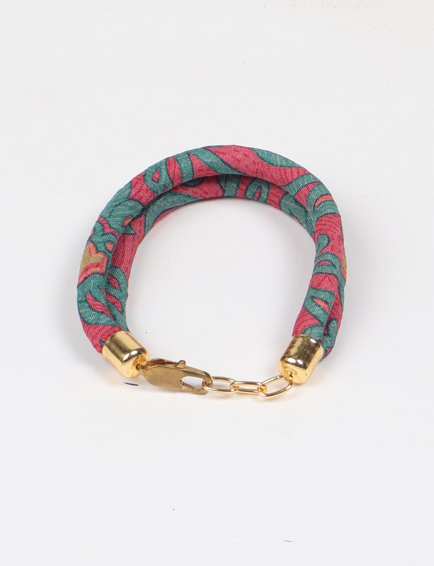 A close-up image of a hand wearing the Sari Rope bracelet, showcasing its colorful threads and unique design. This accessory embodies ethical fashion and sustainability, crafted from repurposed saris for a stylish and eco-conscious statement.