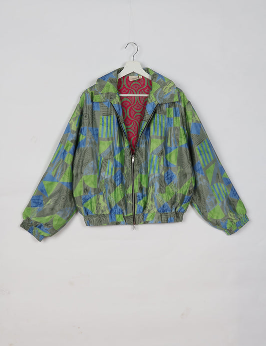 Upcycled Bomber Jacket made from recycled sari materials, featuring a cute cropped shape, elasticated hem and cuffs, and contrast sari print lining. Sustainable apparel promoting eco-friendly fashion and ethical clothing.