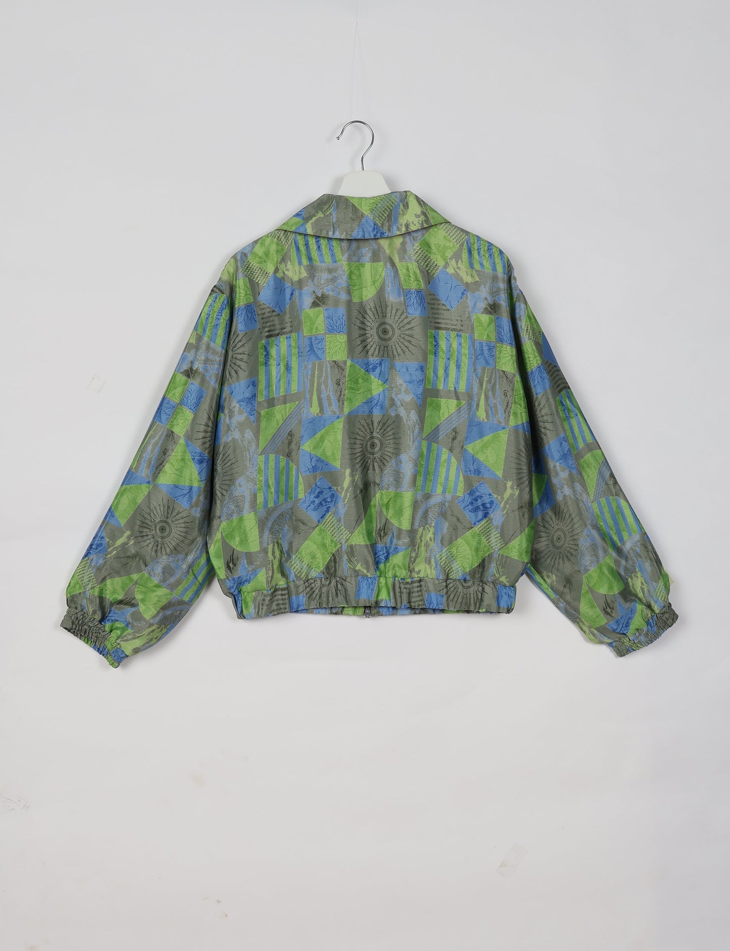 Upcycled Bomber Jacket made from recycled sari materials, featuring a cute cropped shape, elasticated hem and cuffs, and contrast sari print lining. Sustainable apparel promoting eco-friendly fashion and ethical clothing.