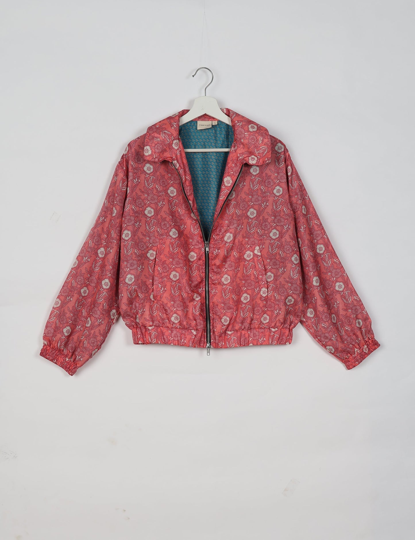 Upcycled Bomber Jacket made from recycled sari materials, featuring a cute cropped shape, elasticated hem and cuffs, and contrast sari print lining. Sustainable apparel promoting eco-friendly fashion and ethical clothing.
