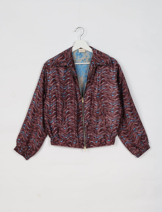 Upcycled Bomber Jacket made from recycled sari materials, featuring a cute cropped shape, elasticated hem and cuffs, and contrast sari print lining. Sustainable apparel promoting eco-friendly fashion and ethical clothing.