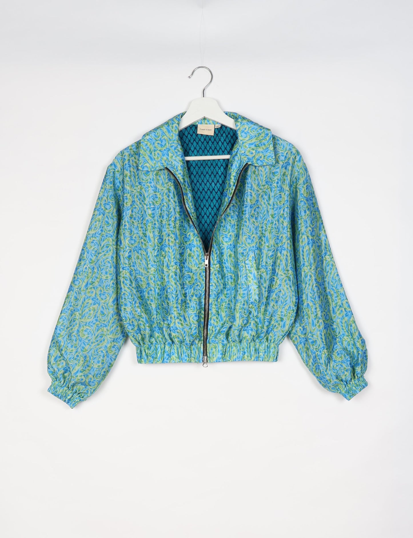 Upcycled Bomber Jacket made from recycled sari materials, featuring a cute cropped shape, elasticated hem and cuffs, and contrast sari print lining. Sustainable apparel promoting eco-friendly fashion and ethical clothing.