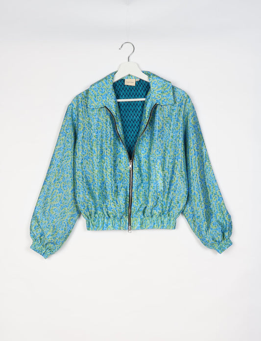 Upcycled Bomber Jacket made from recycled sari materials, featuring a cute cropped shape, elasticated hem and cuffs, and contrast sari print lining. Sustainable apparel promoting eco-friendly fashion and ethical clothing.
