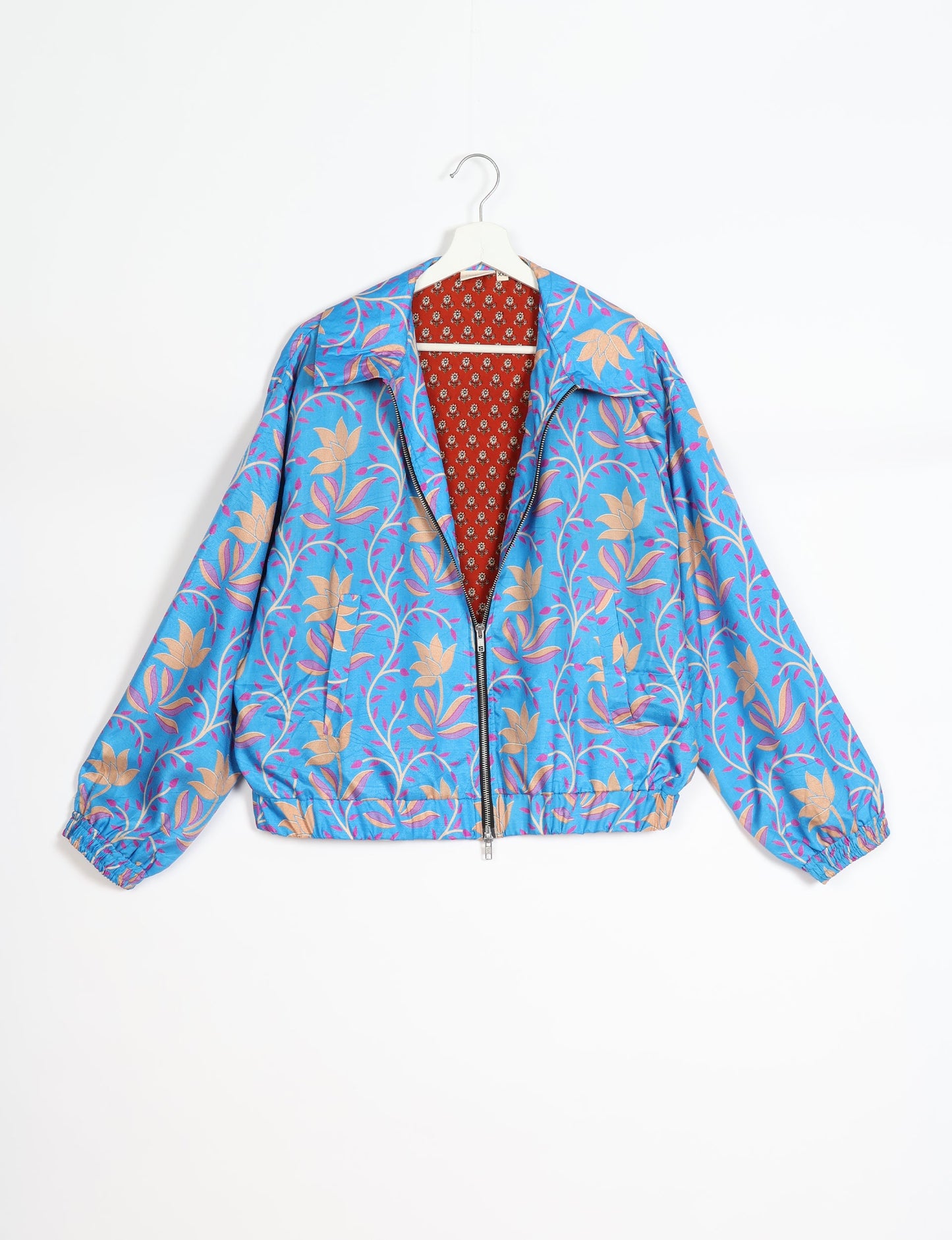 Stylish BOMBER JACKET, an upcycled clothing masterpiece with a cute cropped shape, elasticated details, and detachable metallic zipper. Contrast sari print lining adds a unique touch. Explore sustainable and eco-friendly fashion.