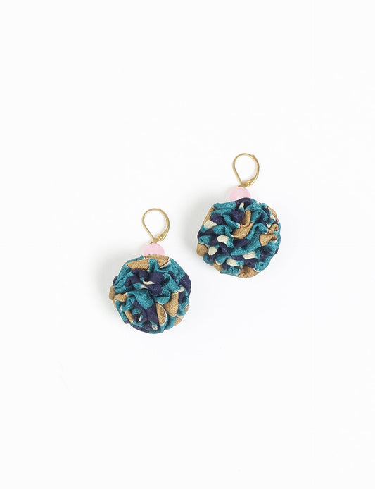 Elevate your style with our Ruffle Earrings, adorned with unique ruffle ball florets crafted from upcycled Indian saris using the traditional Aari embroidery technique. These sustainable earrings feature two glass beads and nickel-free, hypoallergenic metal hooks. Embrace ethical and green fashion with these statement pieces.