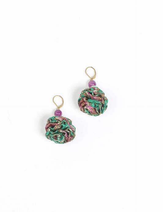 Elevate your style with our Ruffle Earrings, adorned with unique ruffle ball florets crafted from upcycled Indian saris using the traditional Aari embroidery technique. These sustainable earrings feature two glass beads and nickel-free, hypoallergenic metal hooks. Embrace ethical and green fashion with these statement pieces.