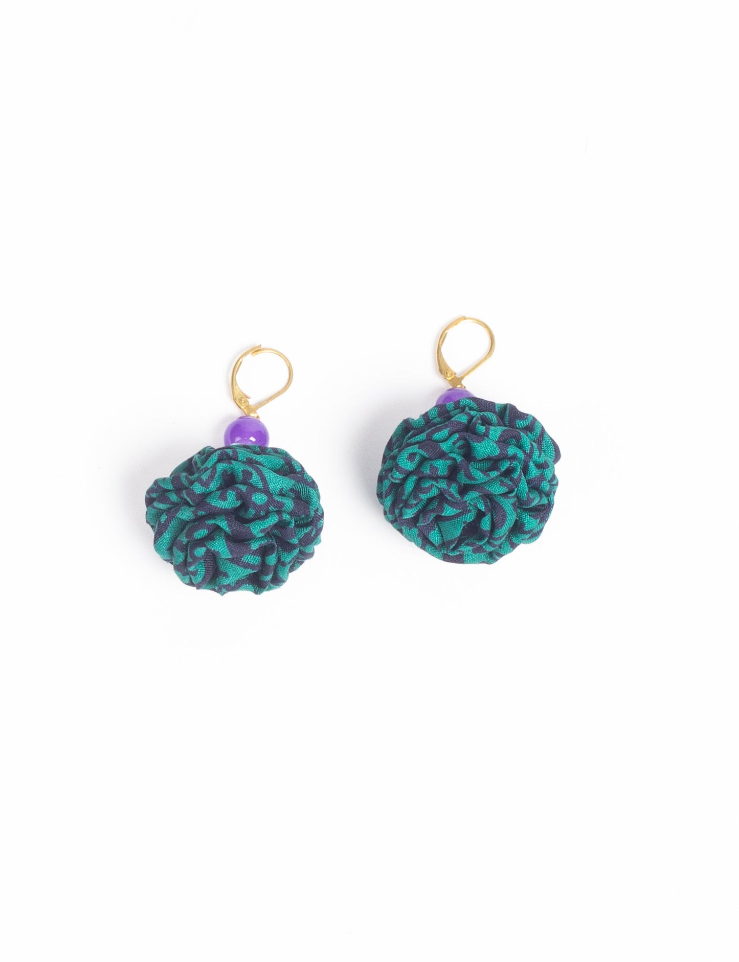 Elevate your style with our Ruffle Earrings, adorned with unique ruffle ball florets crafted from upcycled Indian saris using the traditional Aari embroidery technique. These sustainable earrings feature two glass beads and nickel-free, hypoallergenic metal hooks. Embrace ethical and green fashion with these statement pieces.