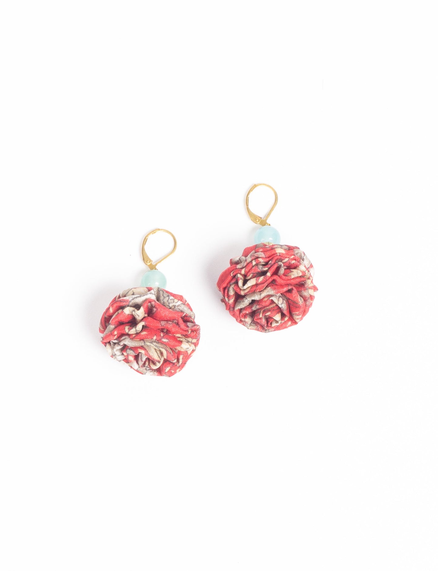 Elevate your style with our Ruffle Earrings, adorned with unique ruffle ball florets crafted from upcycled Indian saris using the traditional Aari embroidery technique. These sustainable earrings feature two glass beads and nickel-free, hypoallergenic metal hooks. Embrace ethical and green fashion with these statement pieces.