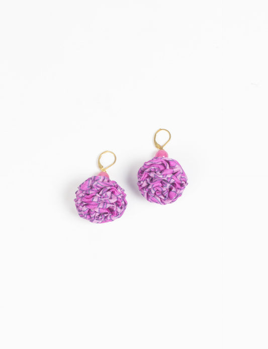 Elevate your style with our Ruffle Earrings, adorned with unique ruffle ball florets crafted from upcycled Indian saris using the traditional Aari embroidery technique. These sustainable earrings feature two glass beads and nickel-free, hypoallergenic metal hooks. Embrace ethical and green fashion with these statement pieces.