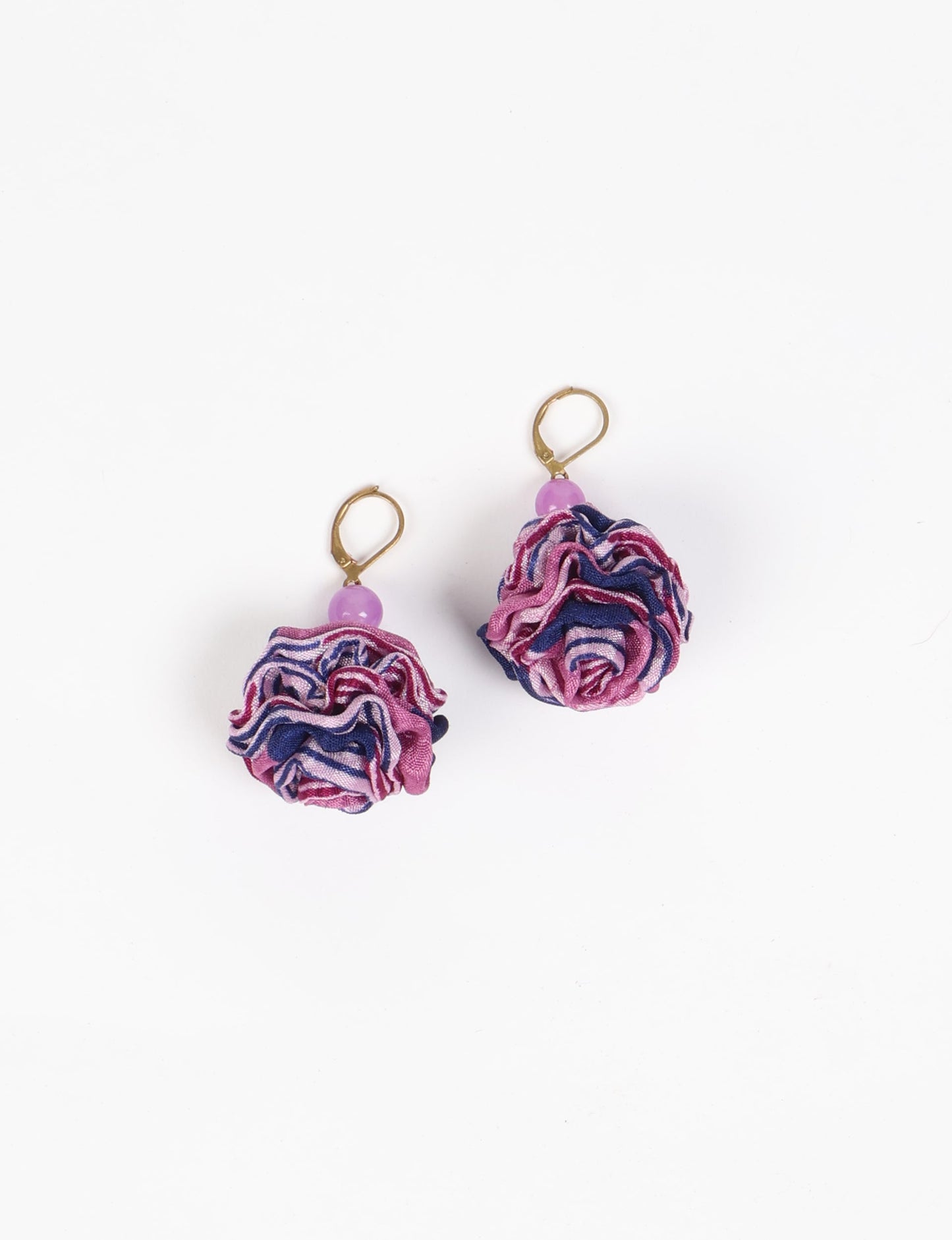 Elevate your style with our Ruffle Earrings, adorned with unique ruffle ball florets crafted from upcycled Indian saris using the traditional Aari embroidery technique. These sustainable earrings feature two glass beads and nickel-free, hypoallergenic metal hooks. Embrace ethical and green fashion with these statement pieces.
