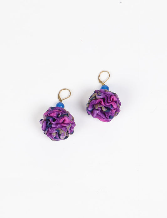 Elevate your style with our Ruffle Earrings, adorned with unique ruffle ball florets crafted from upcycled Indian saris using the traditional Aari embroidery technique. These sustainable earrings feature two glass beads and nickel-free, hypoallergenic metal hooks. Embrace ethical and green fashion with these statement pieces.
