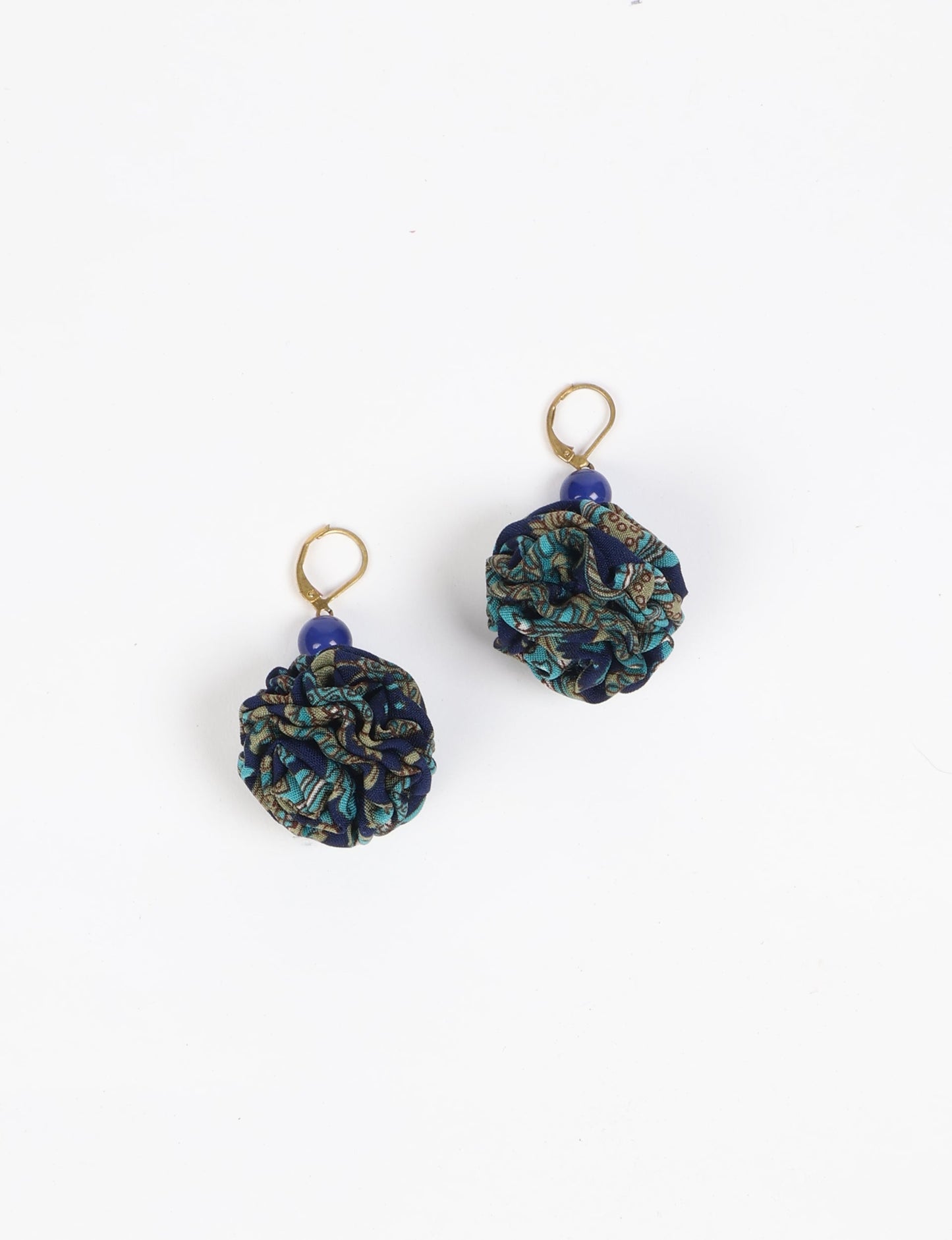 Elevate your style with our Ruffle Earrings, adorned with unique ruffle ball florets crafted from upcycled Indian saris using the traditional Aari embroidery technique. These sustainable earrings feature two glass beads and nickel-free, hypoallergenic metal hooks. Embrace ethical and green fashion with these statement pieces.