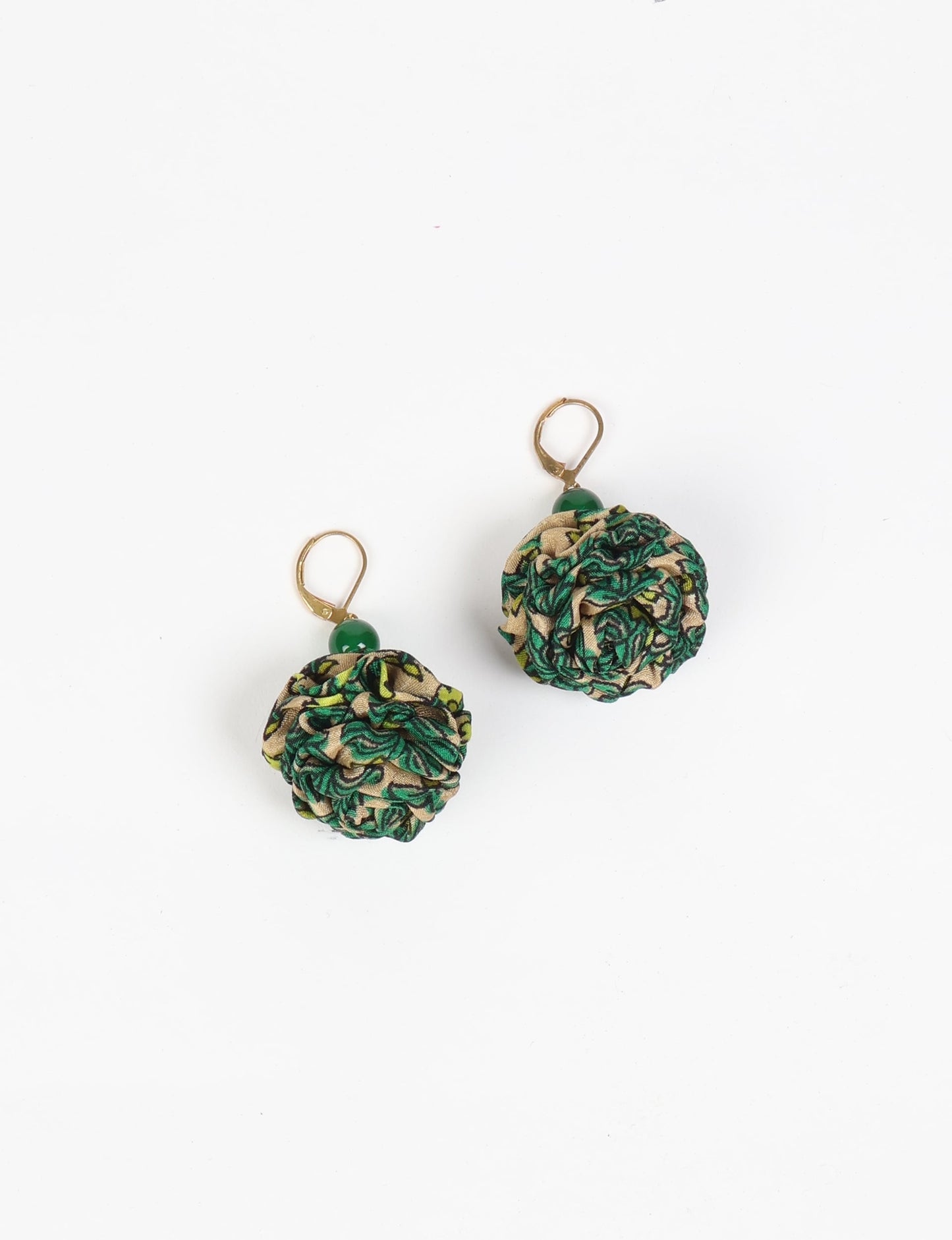 Elevate your style with our Ruffle Earrings, adorned with unique ruffle ball florets crafted from upcycled Indian saris using the traditional Aari embroidery technique. These sustainable earrings feature two glass beads and nickel-free, hypoallergenic metal hooks. Embrace ethical and green fashion with these statement pieces.