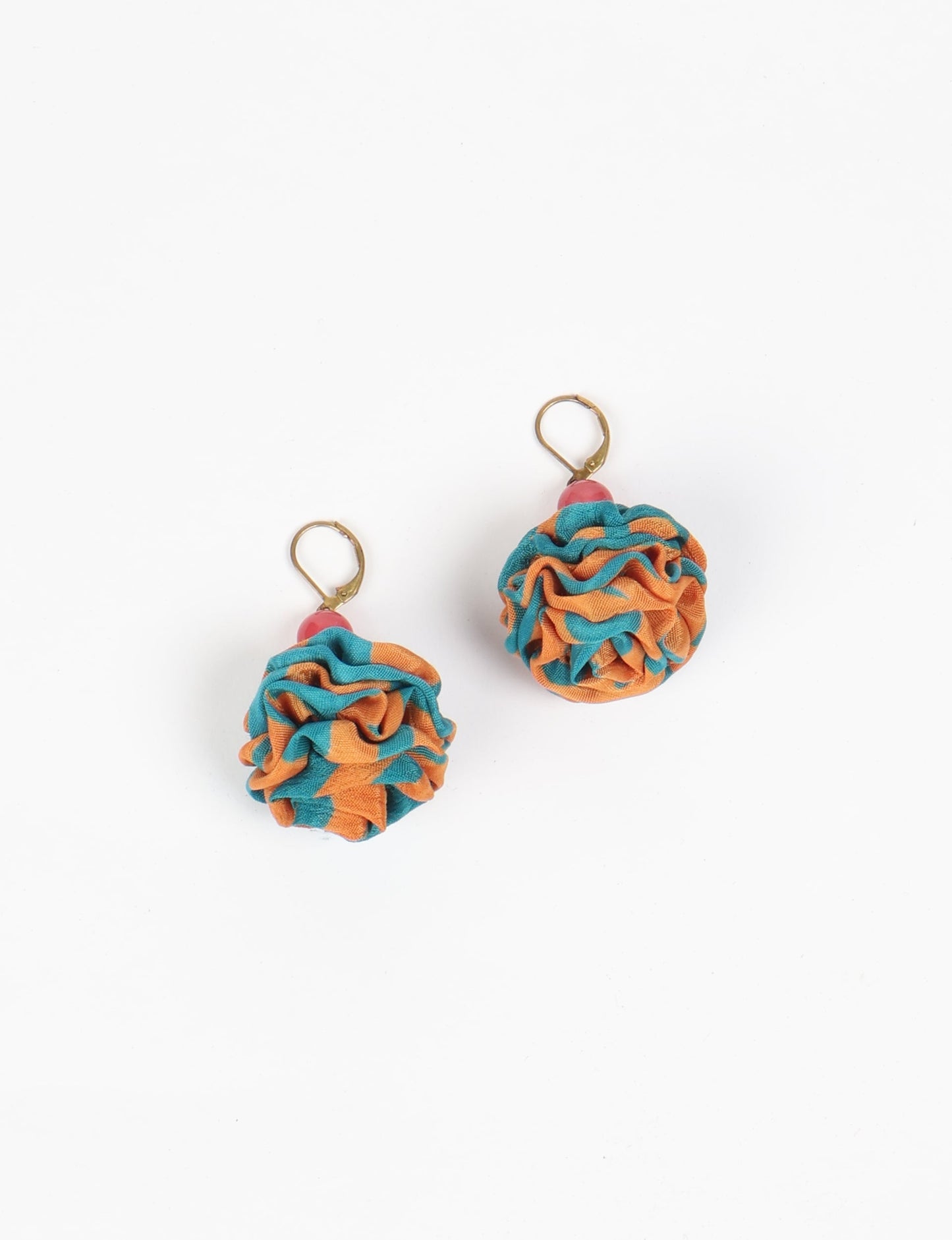 Elevate your style with our Ruffle Earrings, adorned with unique ruffle ball florets crafted from upcycled Indian saris using the traditional Aari embroidery technique. These sustainable earrings feature two glass beads and nickel-free, hypoallergenic metal hooks. Embrace ethical and green fashion with these statement pieces.